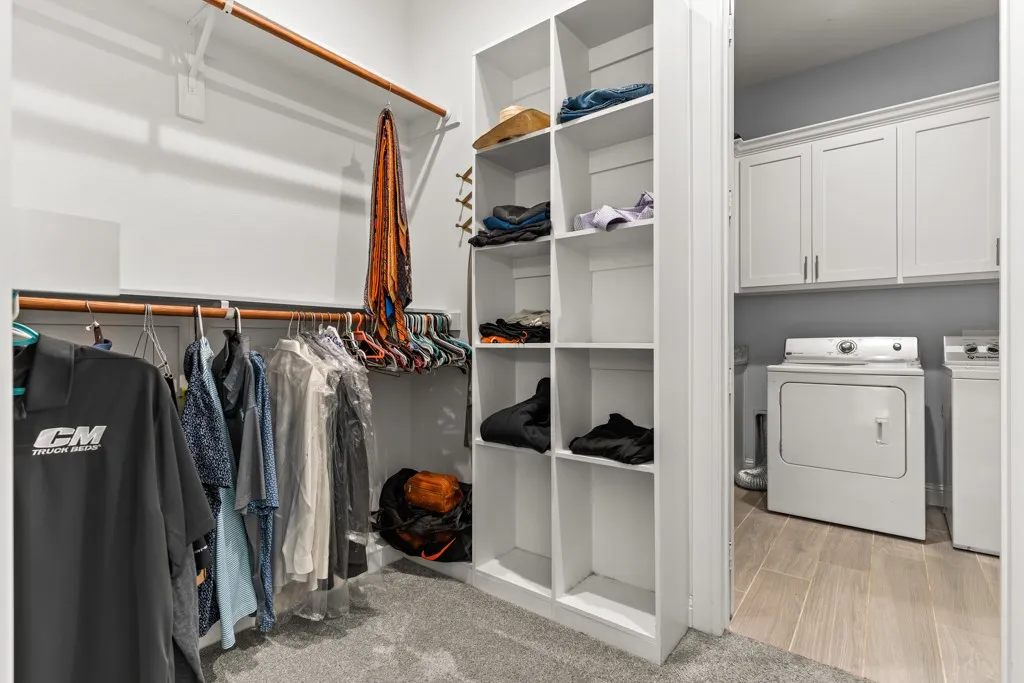 Custom closet system with multiple hanging rods and integrated shelving