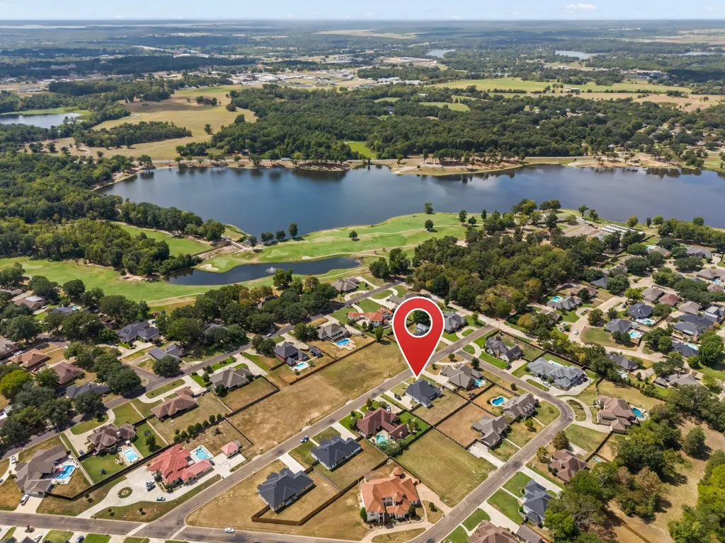 Aerial perspective showcasing a residential development, established homes, and undeveloped lots