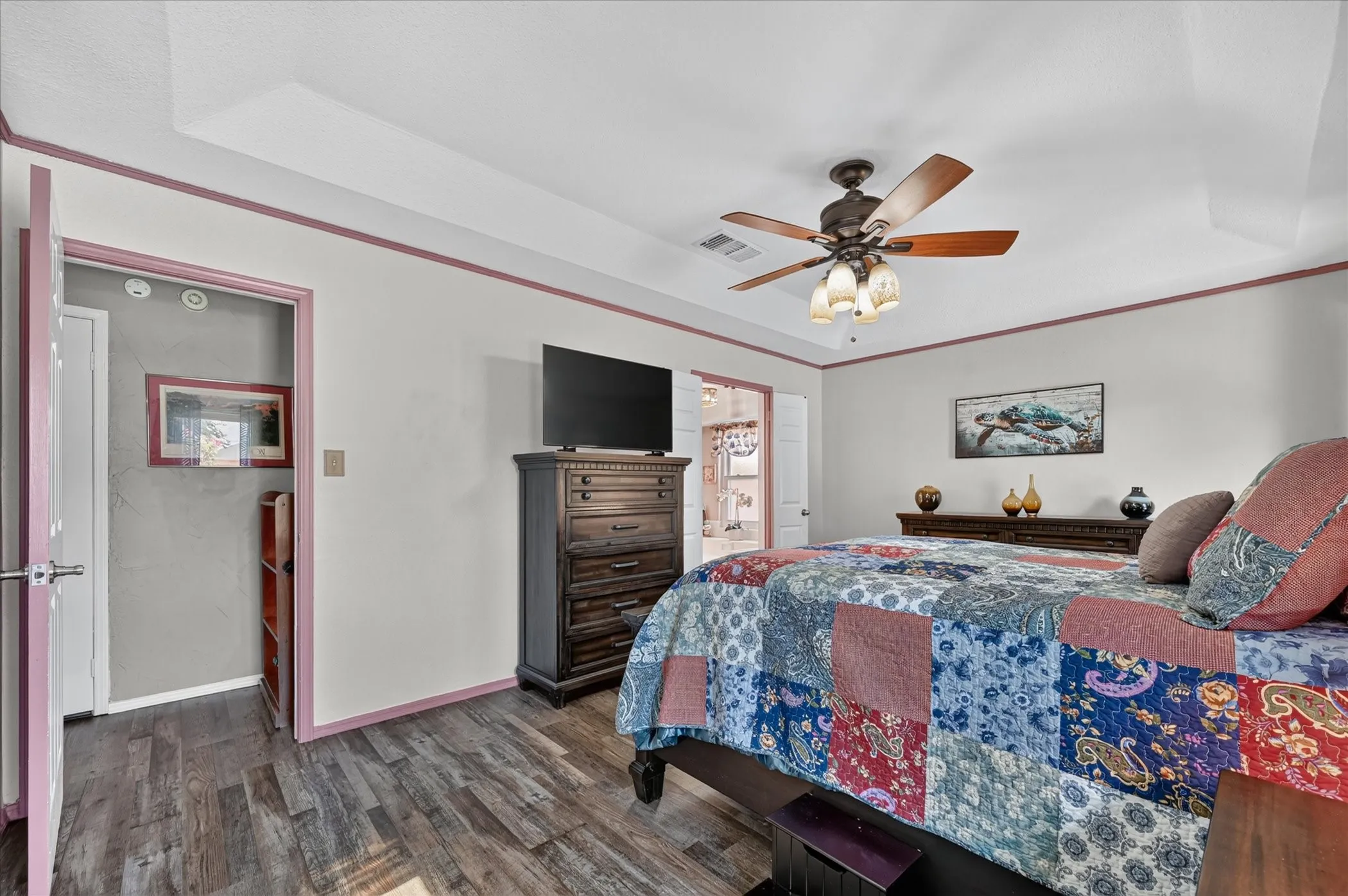 Generously sized primary suite provides ample room for substantial furnishings and offers convenient access to the adjoining bath.