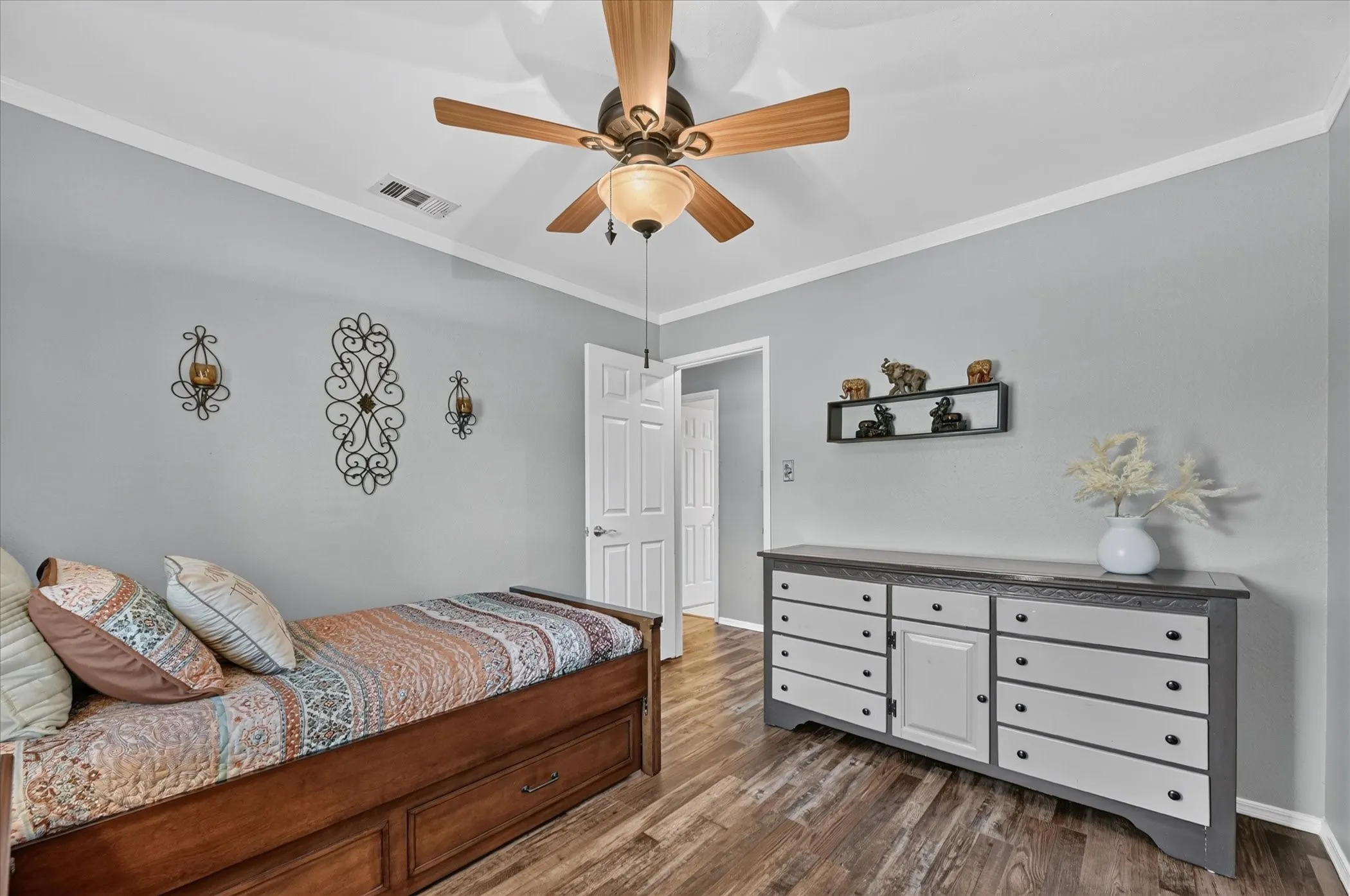 Inviting secondary bedroom provides a versatile layout with wood-look flooring, neutral finishes, and a window offering natural light.