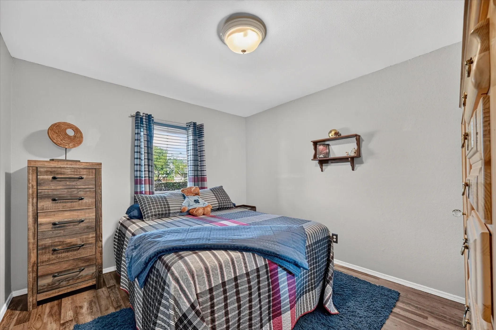 Well-proportioned bedroom offers ample space for furnishings while maintaining a comfortable, functional layout.
