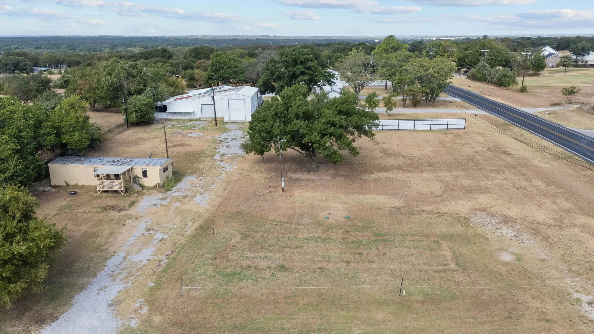 Elevated view of the open commercial site, existing shop and surrounding area.