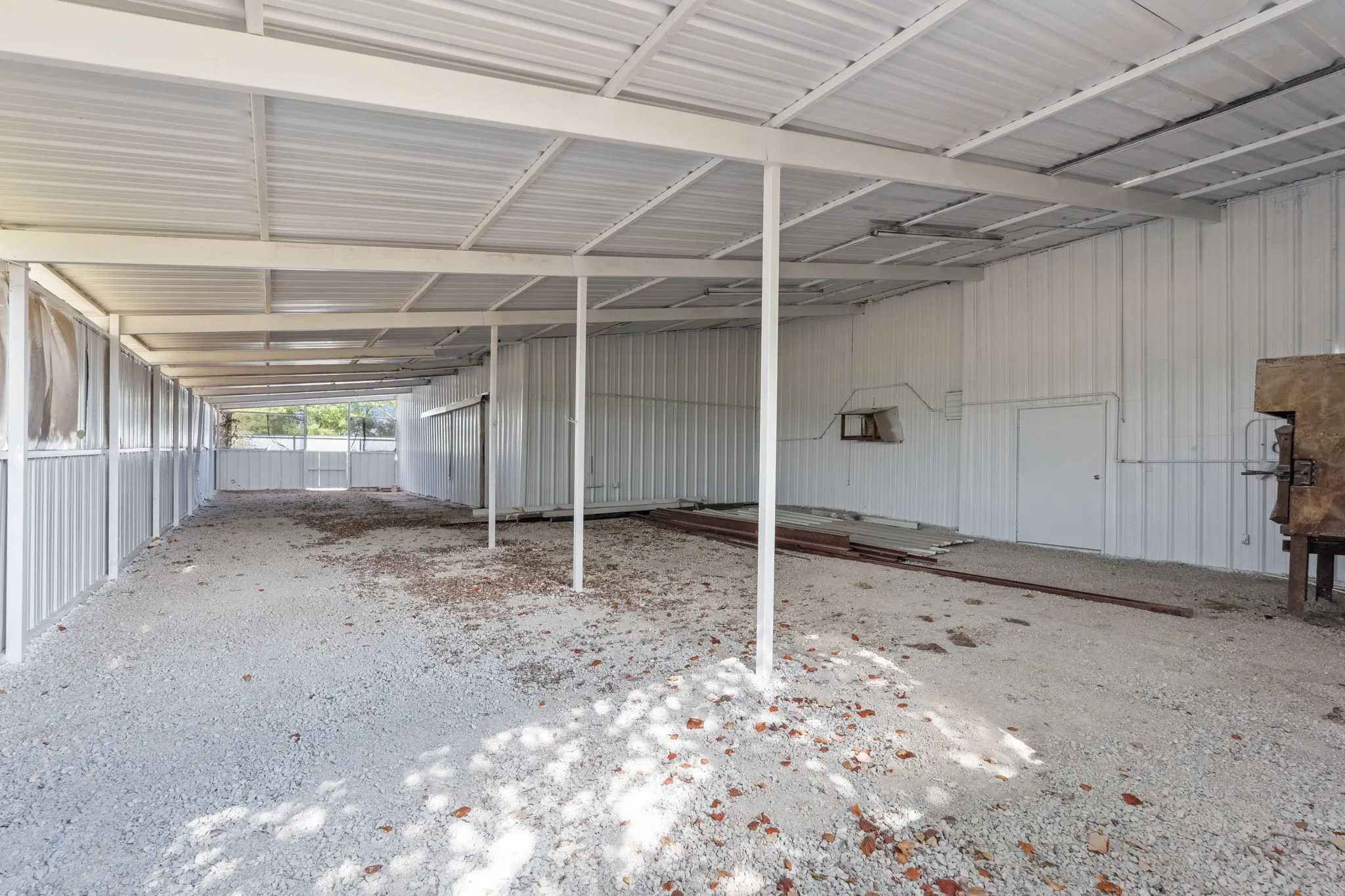 Large covered gravel work and storage area ideal for secure storage, project staging, welding, painting and prep work.