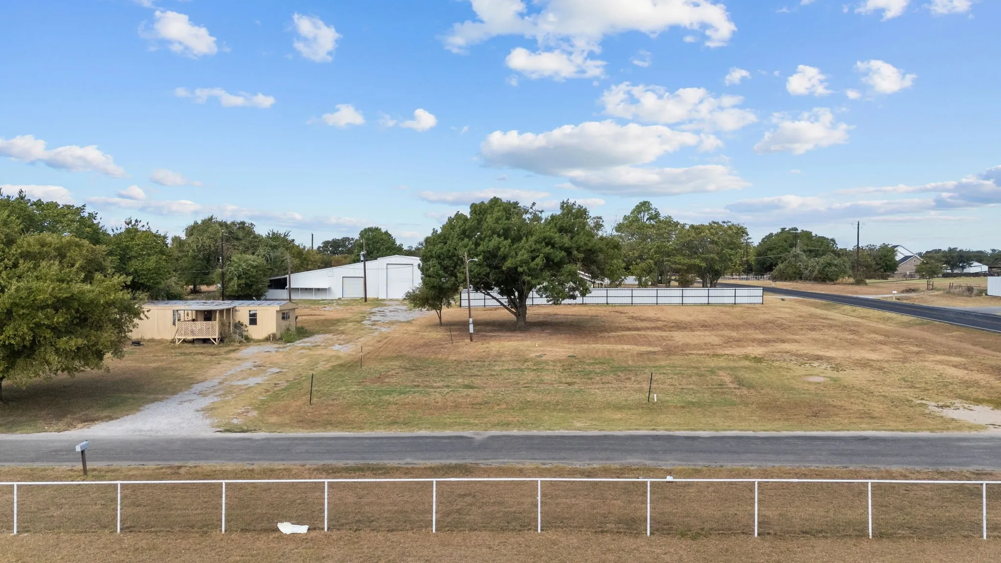 Open commercial land provides room for parking, expansion or future development.
