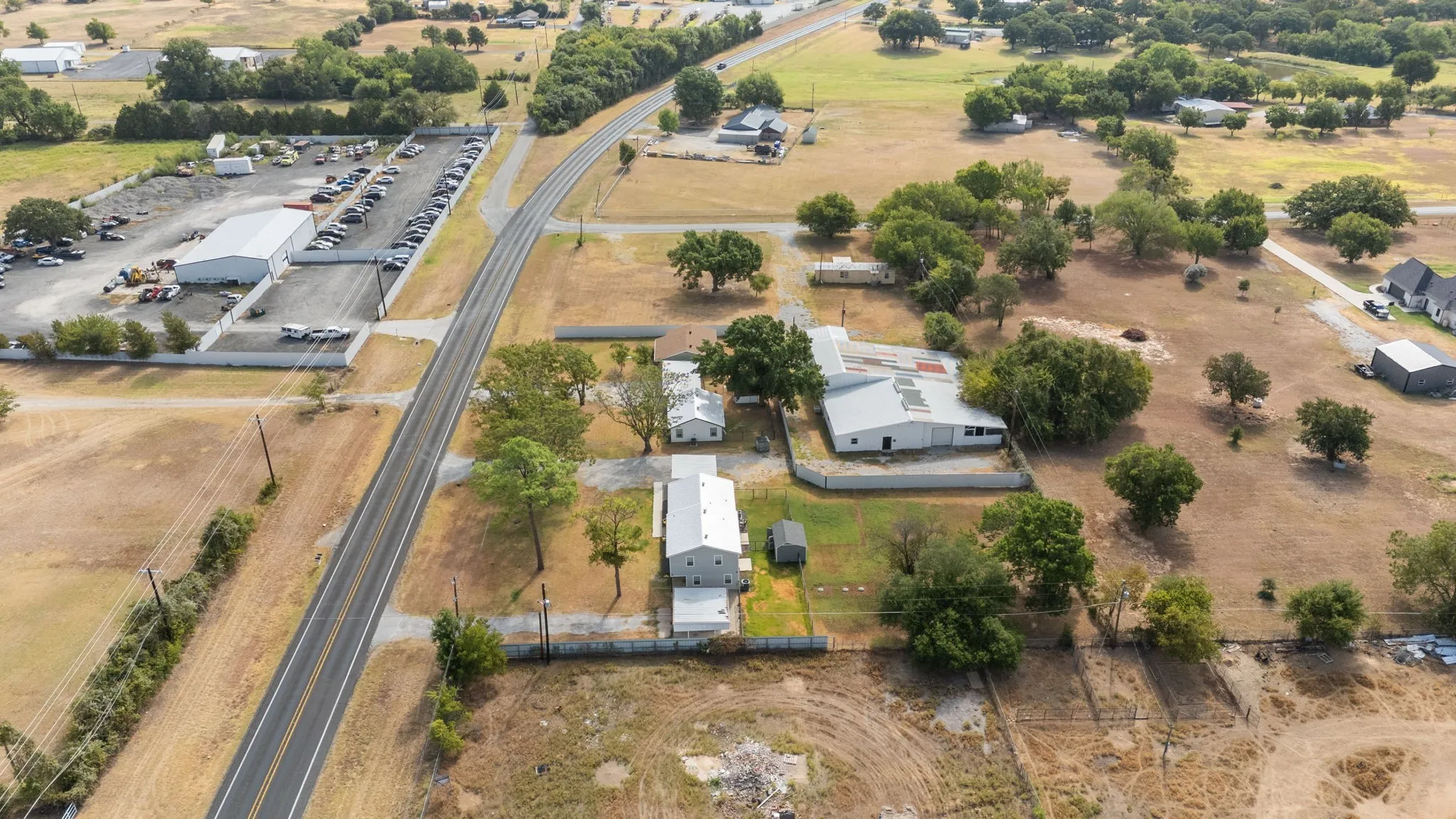 Aerial view showing the property in relation to E Reno Rd, Arvel Cir and nearby commercial uses.