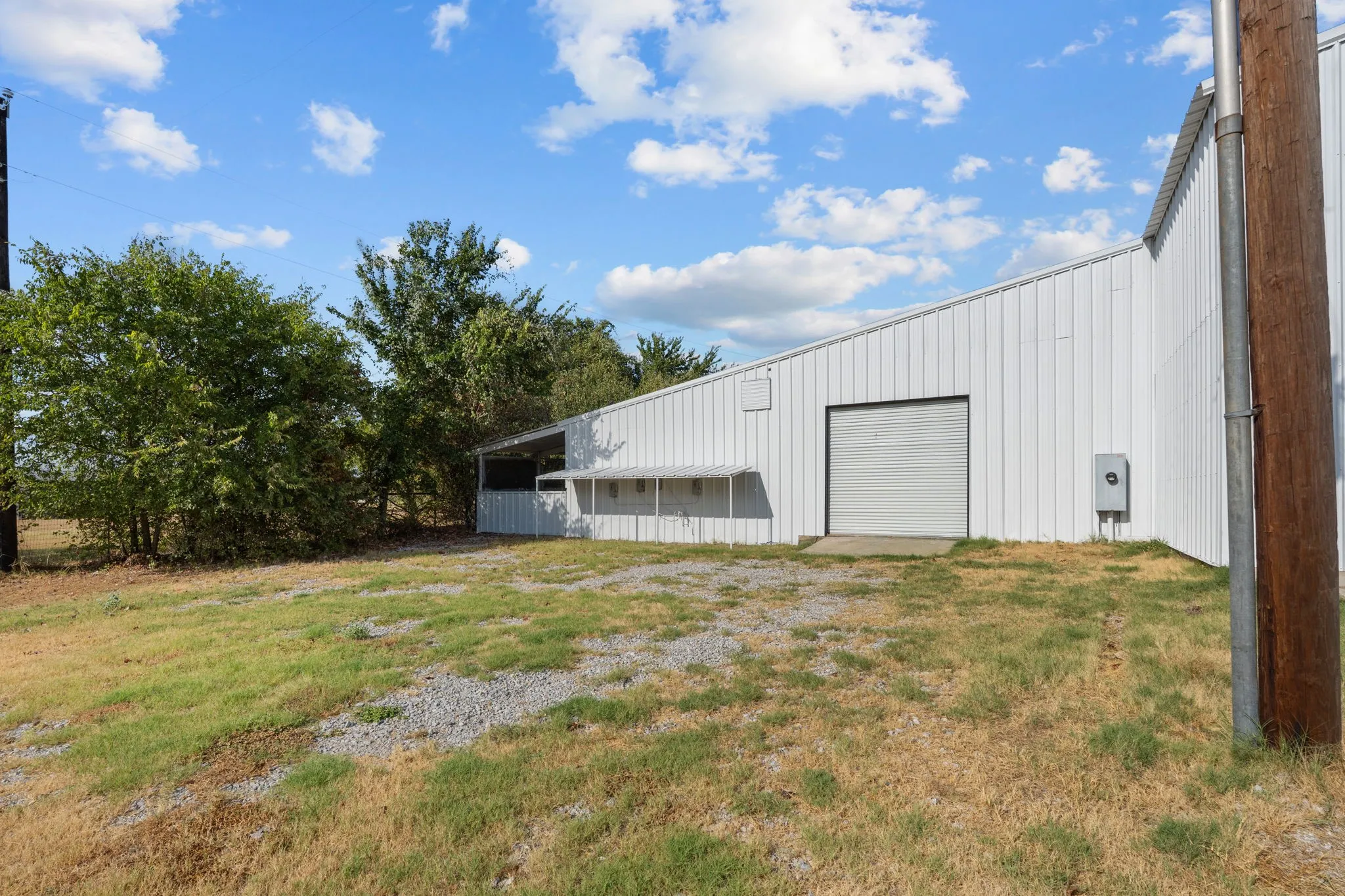 Existing metal commercial shop with multiple work, storage and office areas.