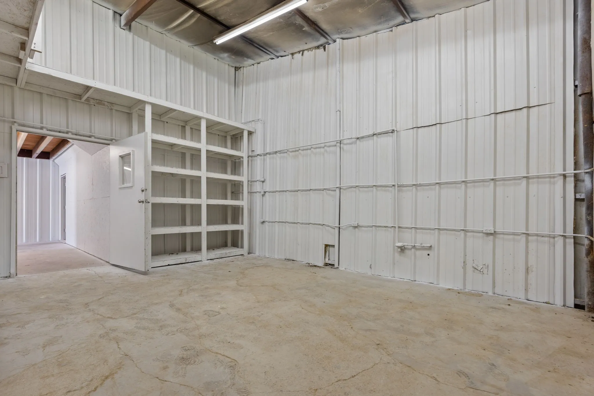 Approx. 12 x 18 work or storage area providing additional flexible space within the shop.