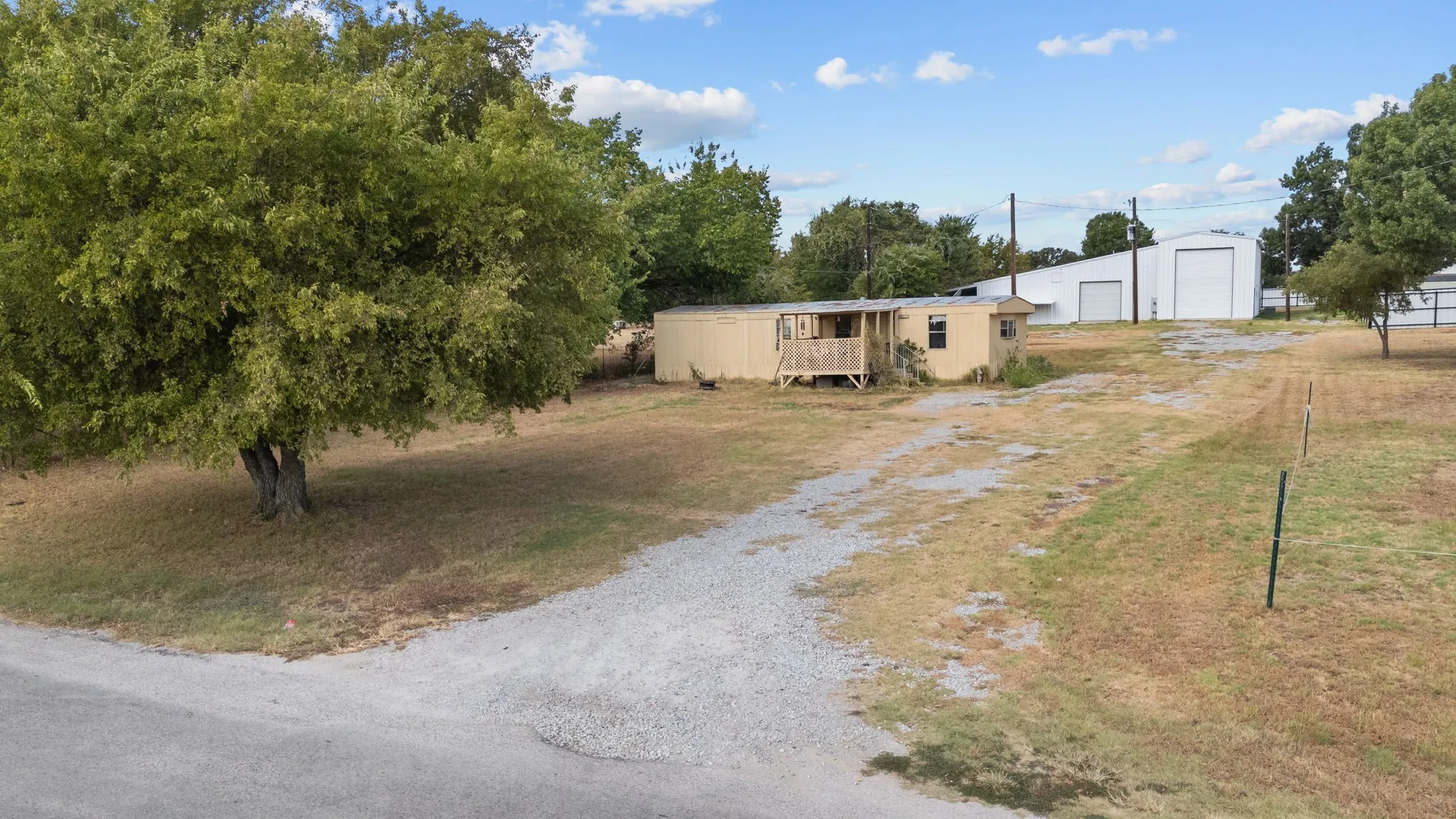 Existing drive access from Arvel Cir with room for vehicles, equipment and business traffic.