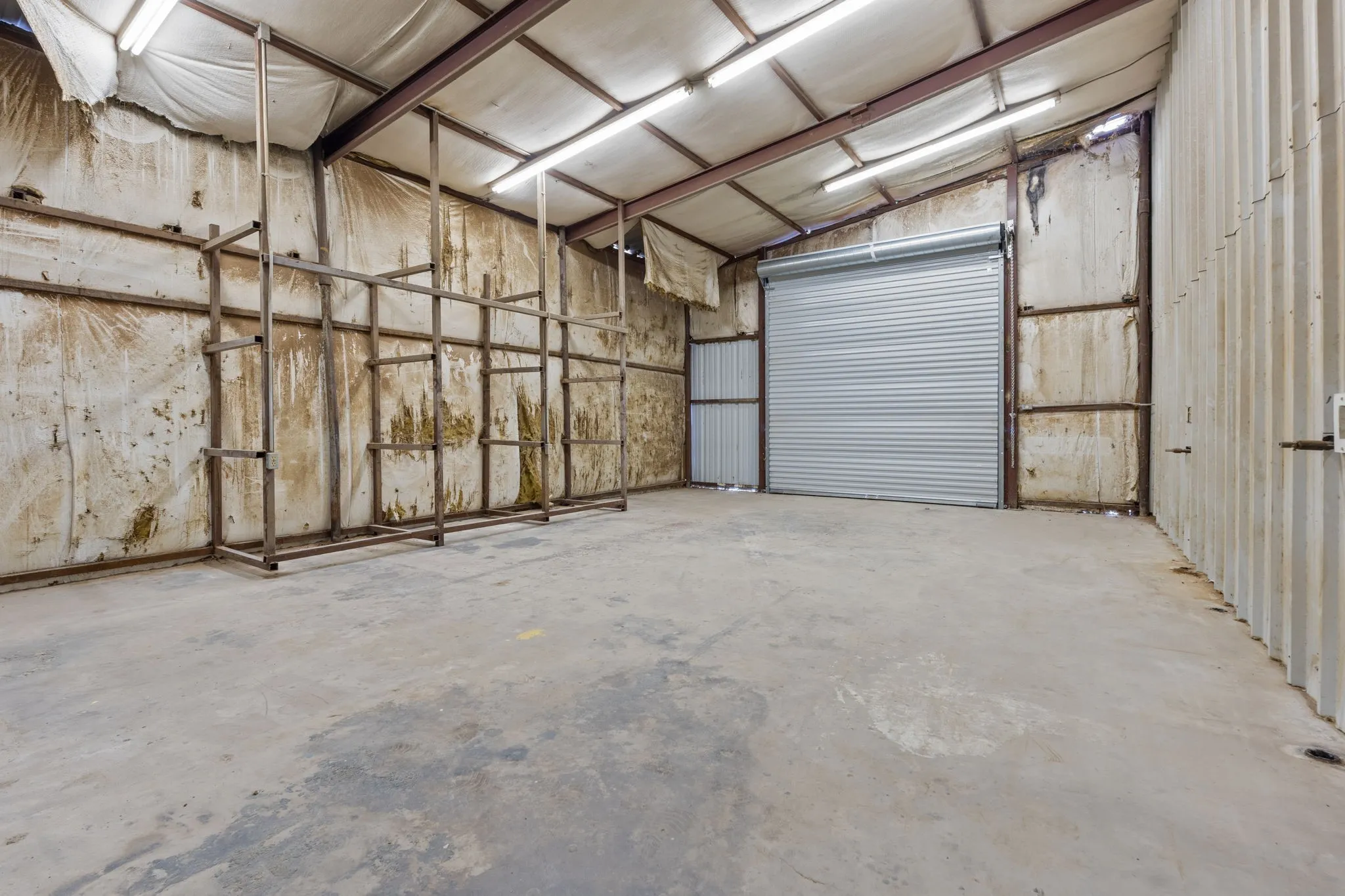 Approx. 29 x 18 workshop with 10-foot roll-up door, electrical and air connections, plus hanging propane heater.