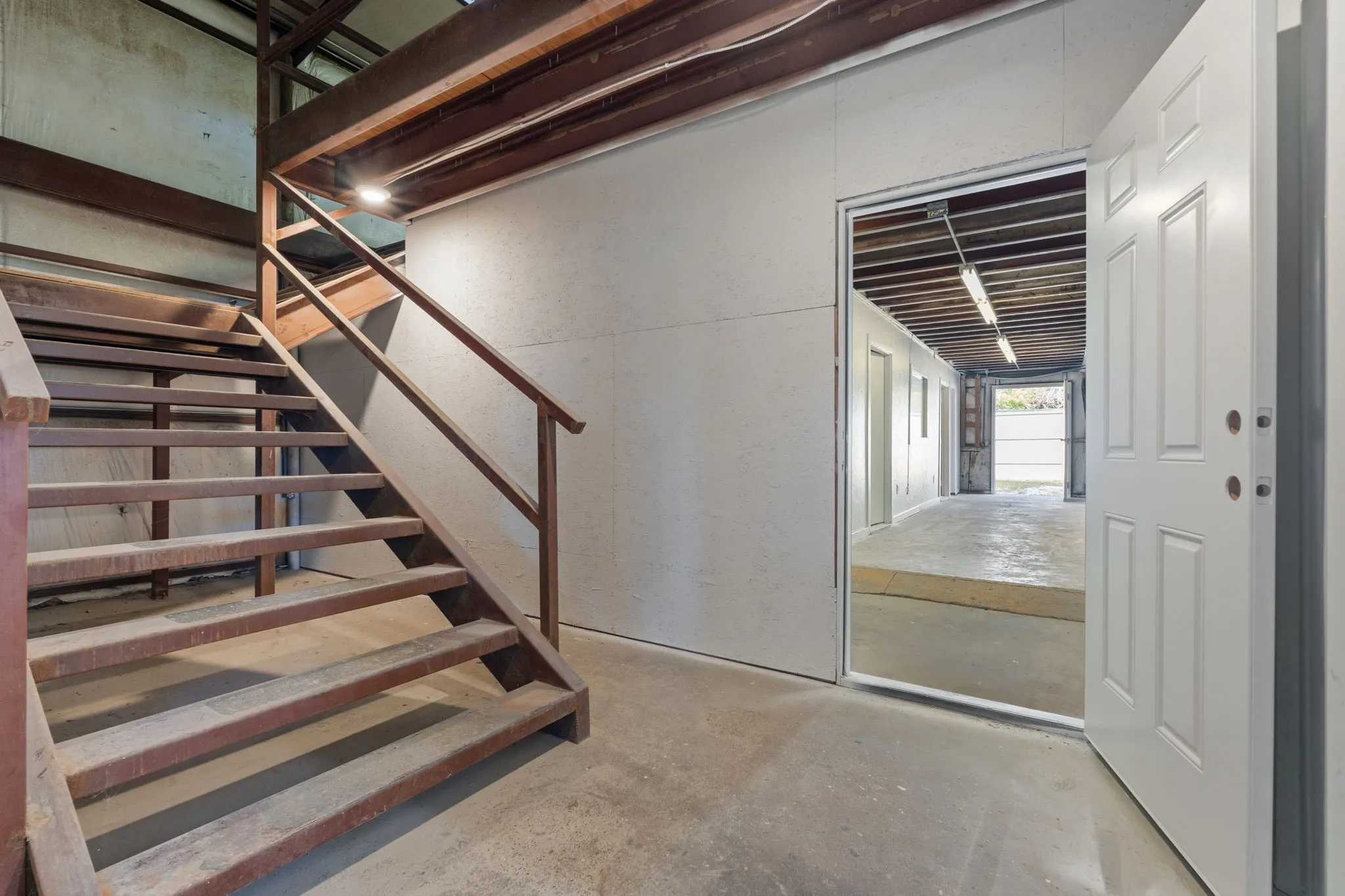 Large central hallway with stair access leading to the second-floor loft area.
