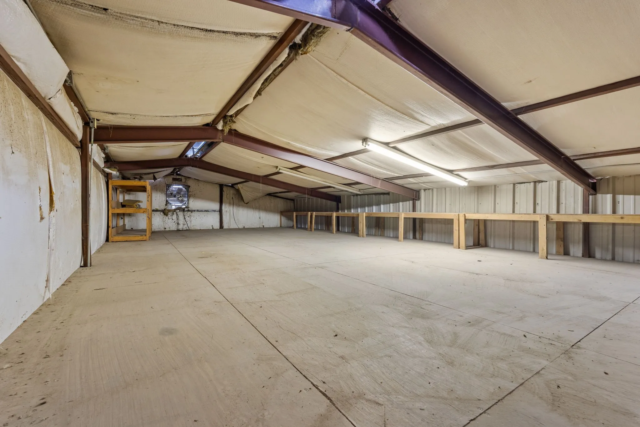 Spacious upper-level loft provides additional storage, work or operational space.