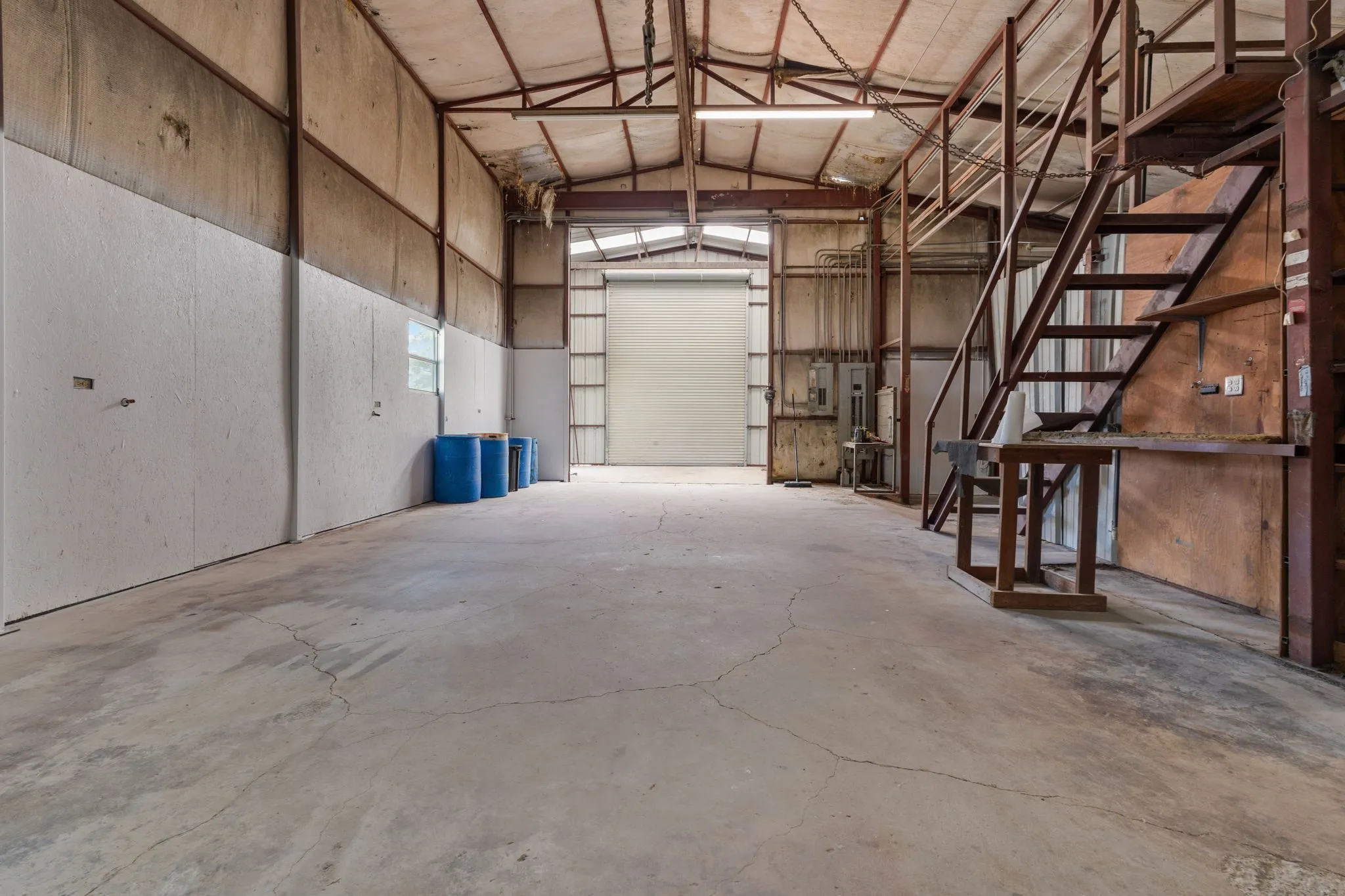 Approx. 40 x 39 main workshop featuring an overhead crane system and substantial open work space.