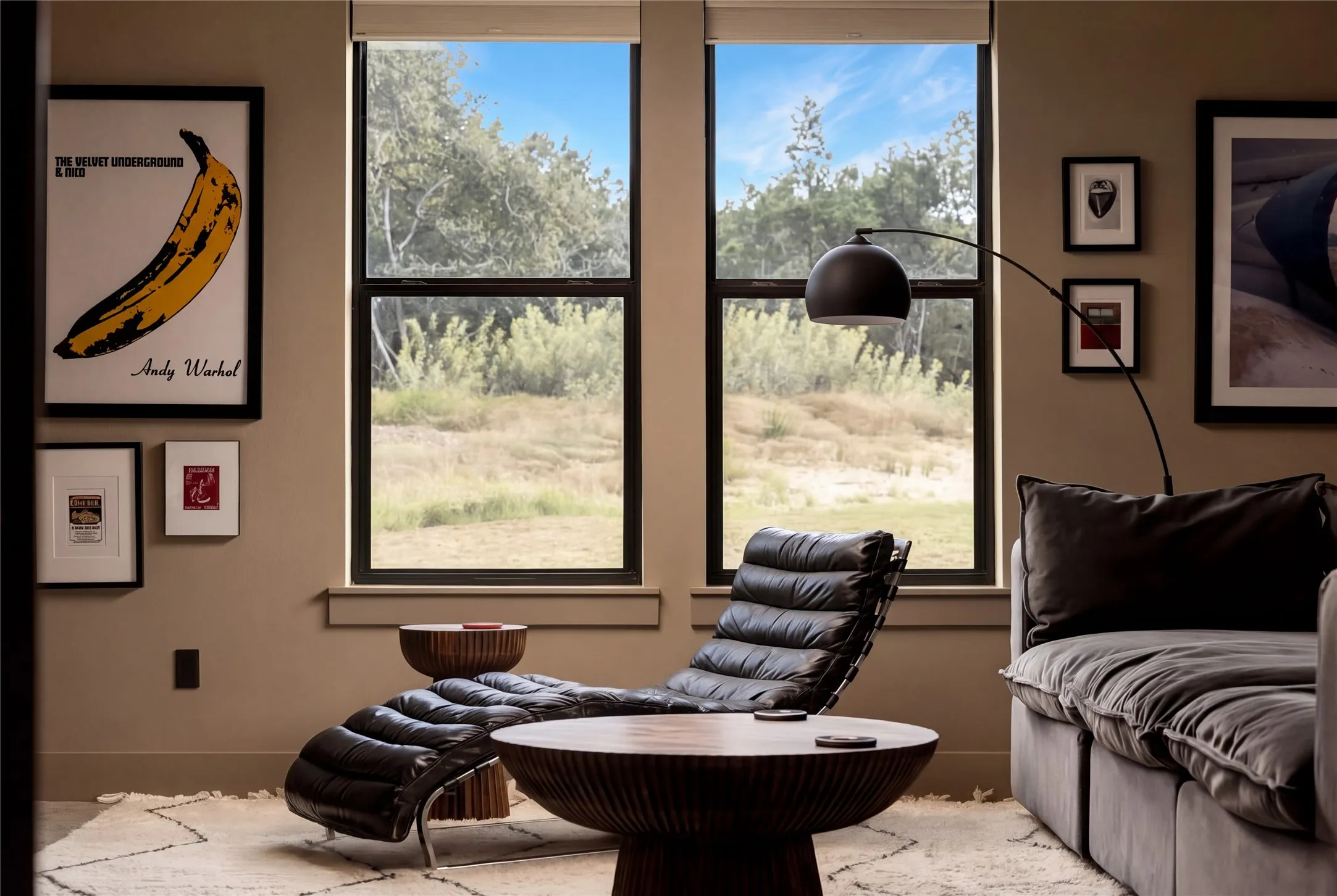 Double hung windows frame serene natural views in this peaceful living space.