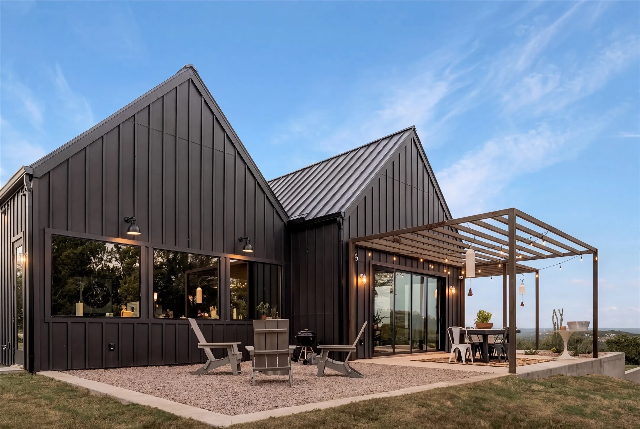 Striking dark vertical siding and a matching metal roof define this modern architectural exterior.