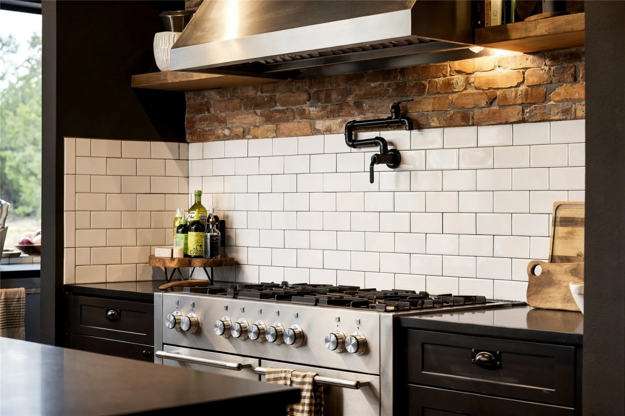 Industrial style shapes this cooking area with exposed brick accents and a professional-grade range.