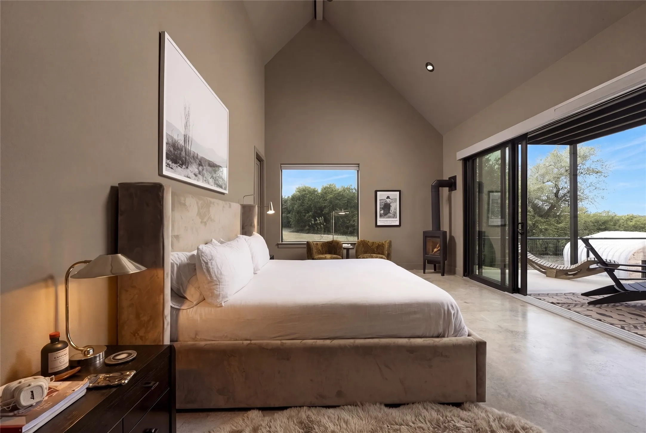 Towering vaulted ceilings and seamless sliding glass doors define this serene main level retreat.