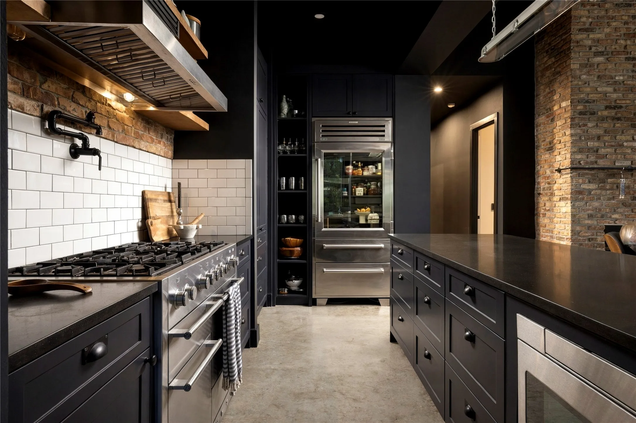 Industrial design elements meet sleek modern finishes in this beautifully crafted kitchen.