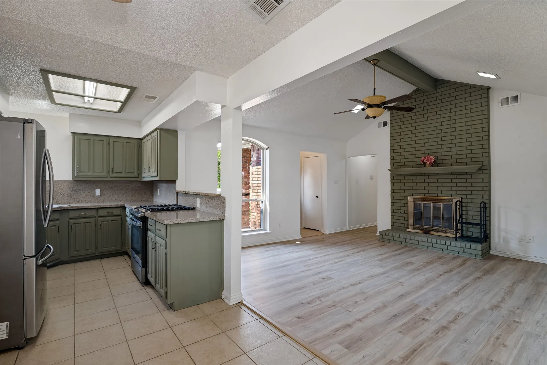 Kitchen featuring green cabinetry, stainless steel appliances
