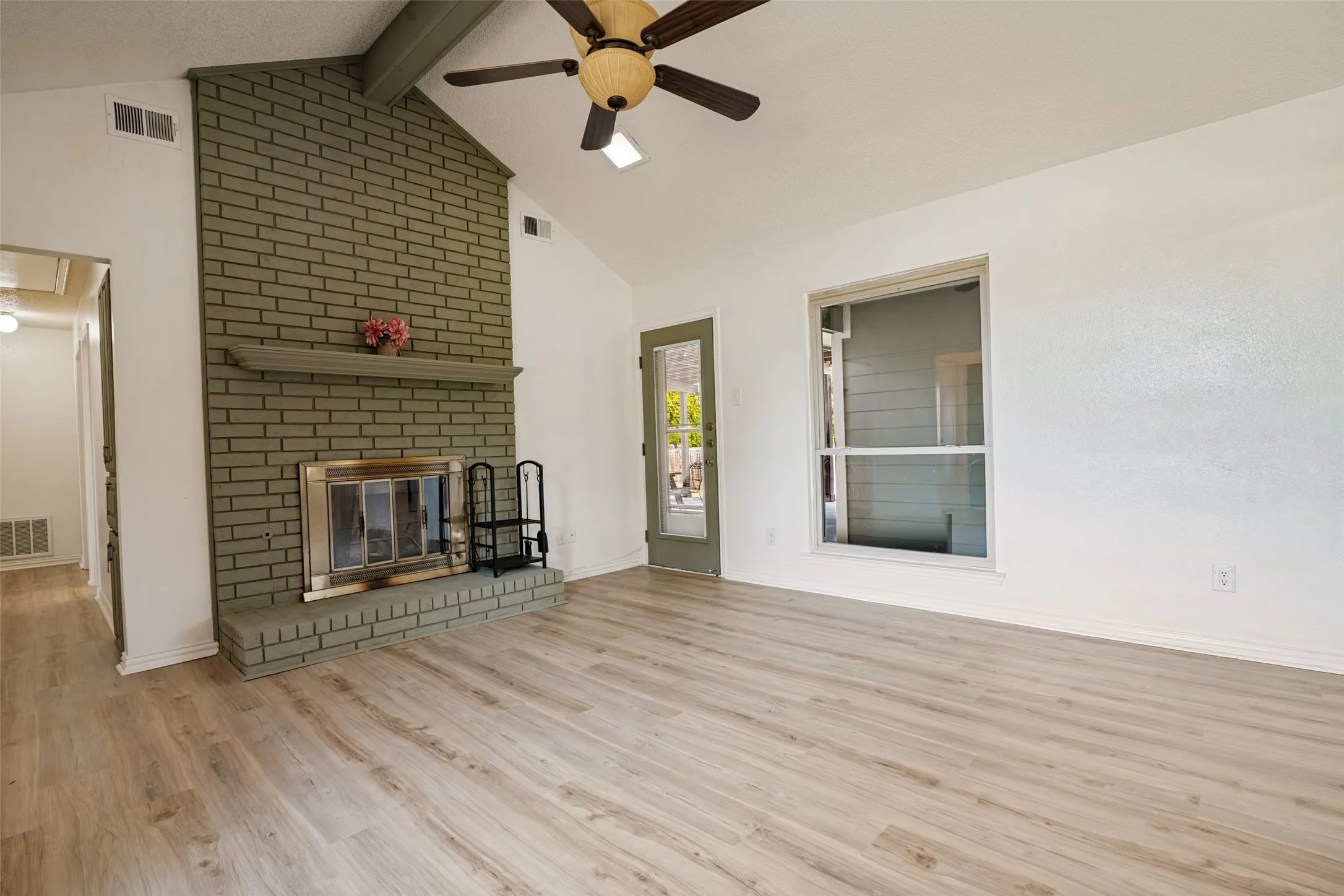 Vaulted ceiling, brick fireplace with mantel