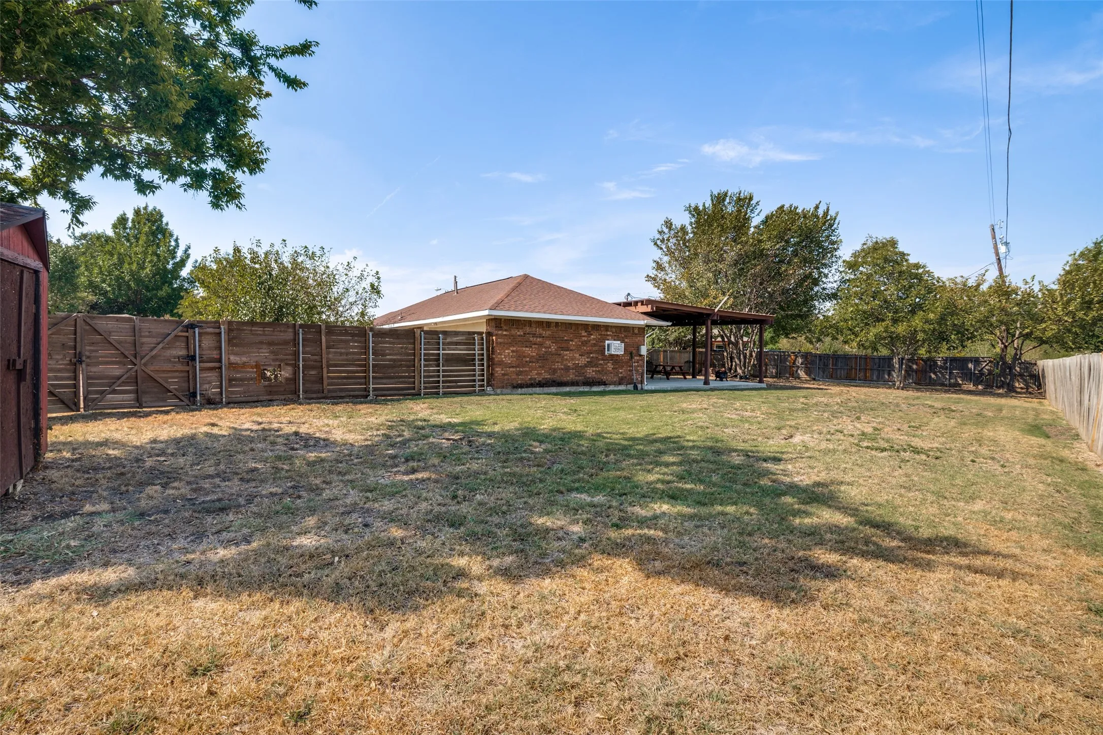 Expansive backyard with a wood privacy fence.