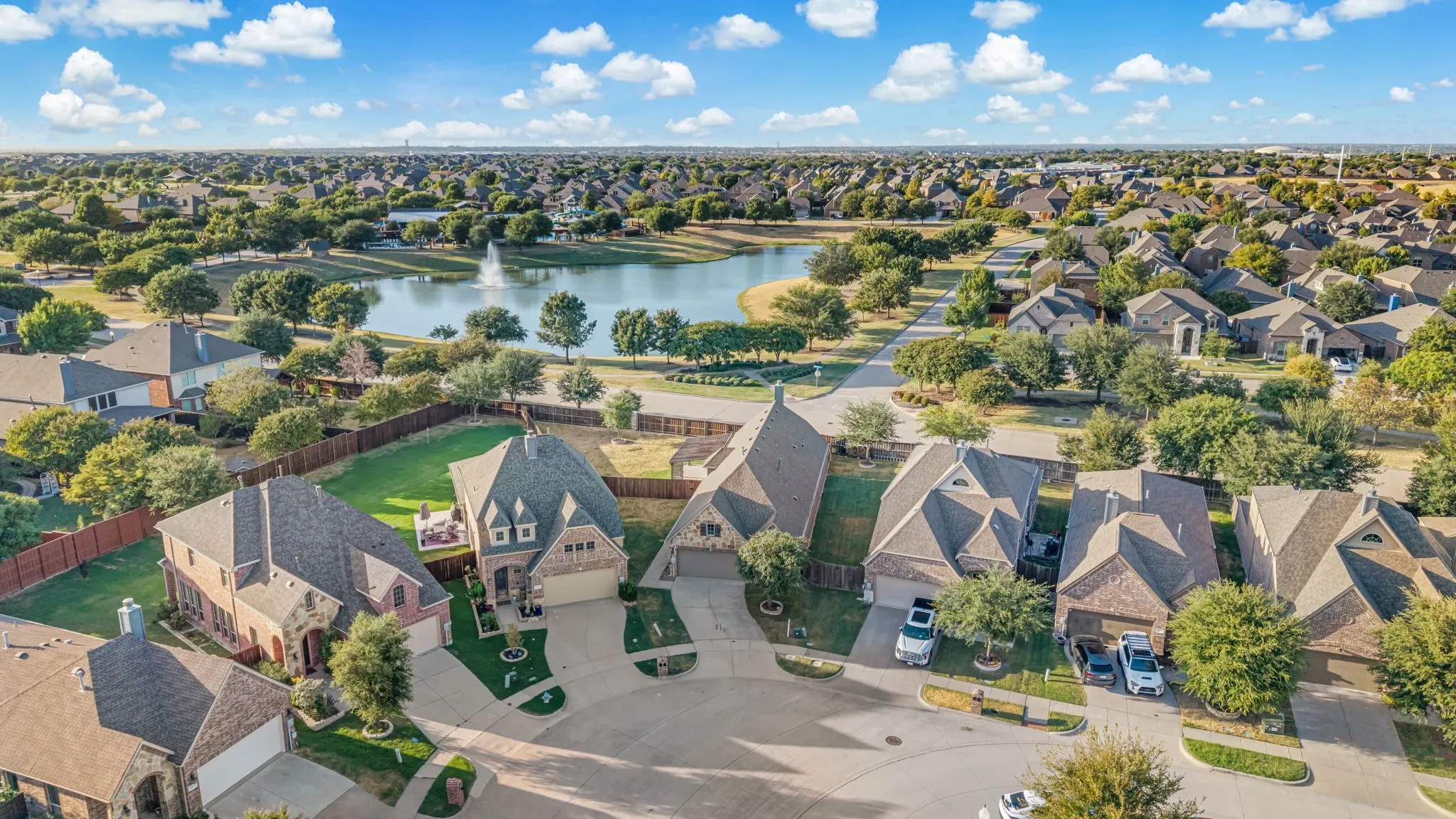 Expansive residential area featuring a central pond with a fountain