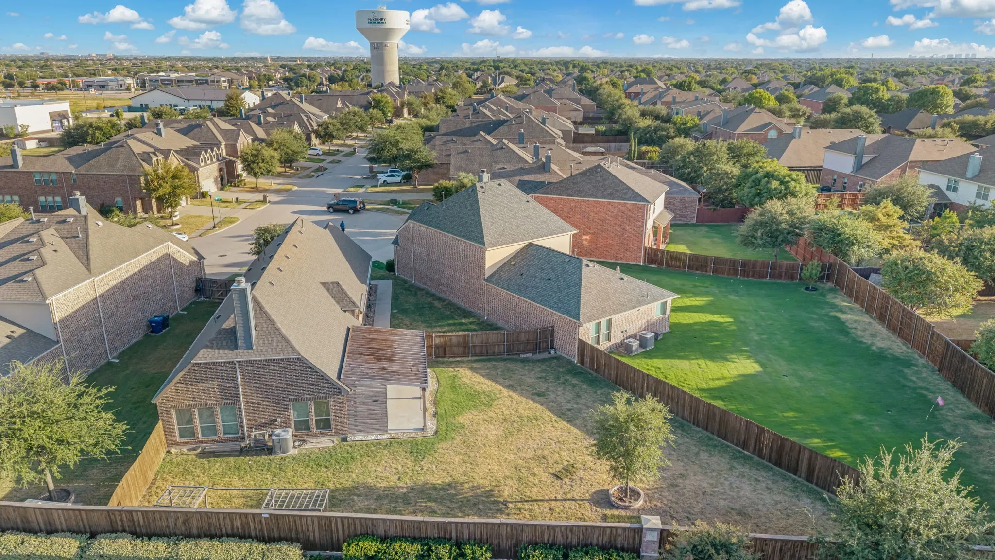 Expansive fenced backyard with manicured lawn