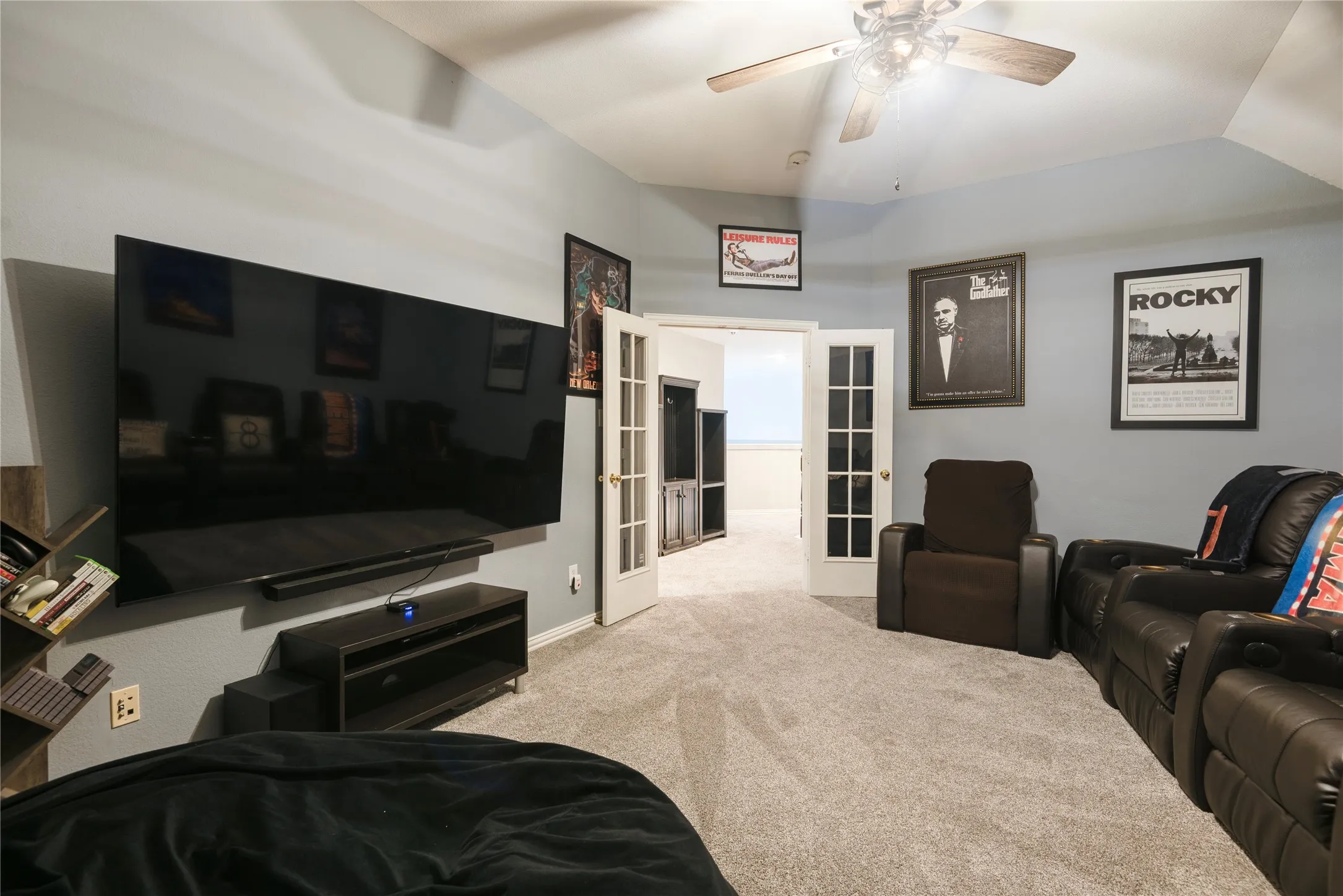 Upstairs game or media room has French doors for privacy.