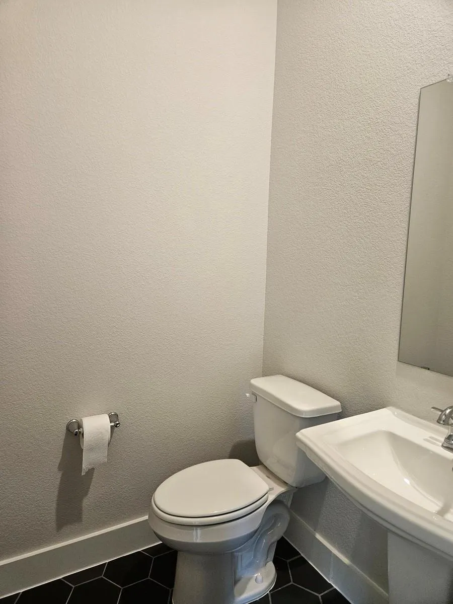 White pedestal sink with chrome faucet