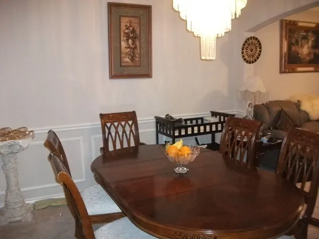 Dining area with a tiered chandelier