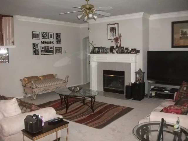 Living area with a fireplace featuring a tile surround and a decorative mantel