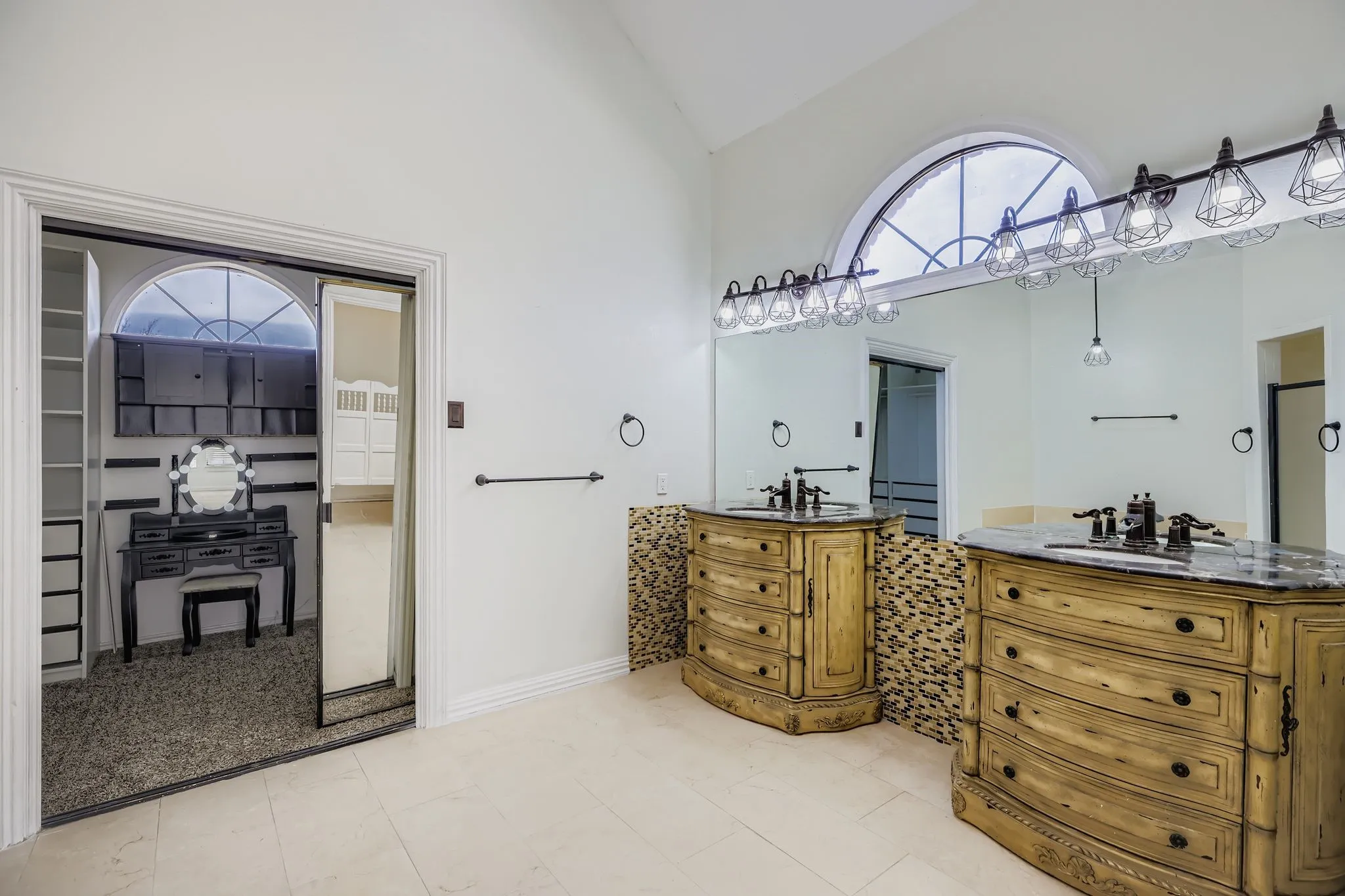Dual vanity with unique distressed wood cabinetry, countertop sinks, and a full-width mirror