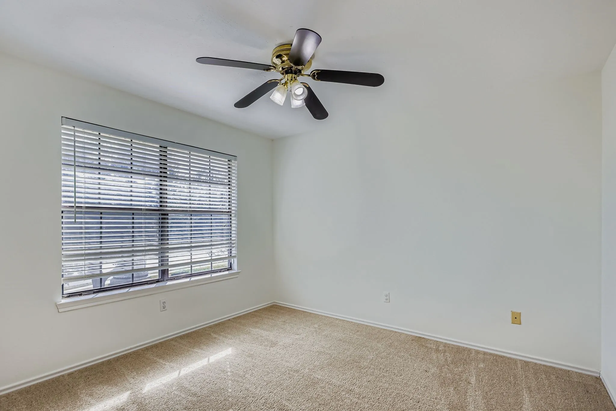 Carpet flooring, window with horizontal blinds, and a ceiling fan with integrated lighting