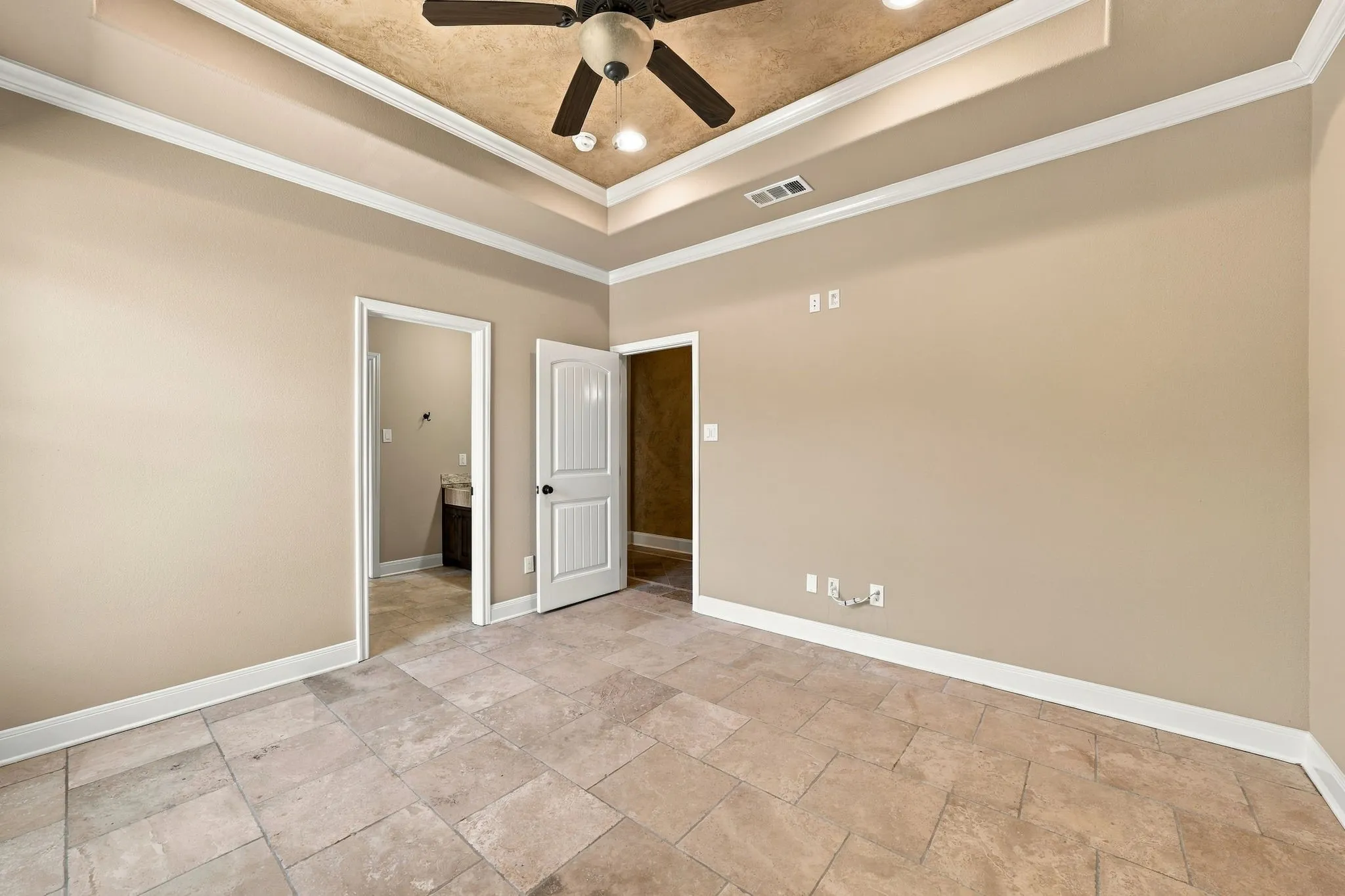 Recessed ceiling with an integrated ceiling fan, tiled flooring, and light-toned wall finishes