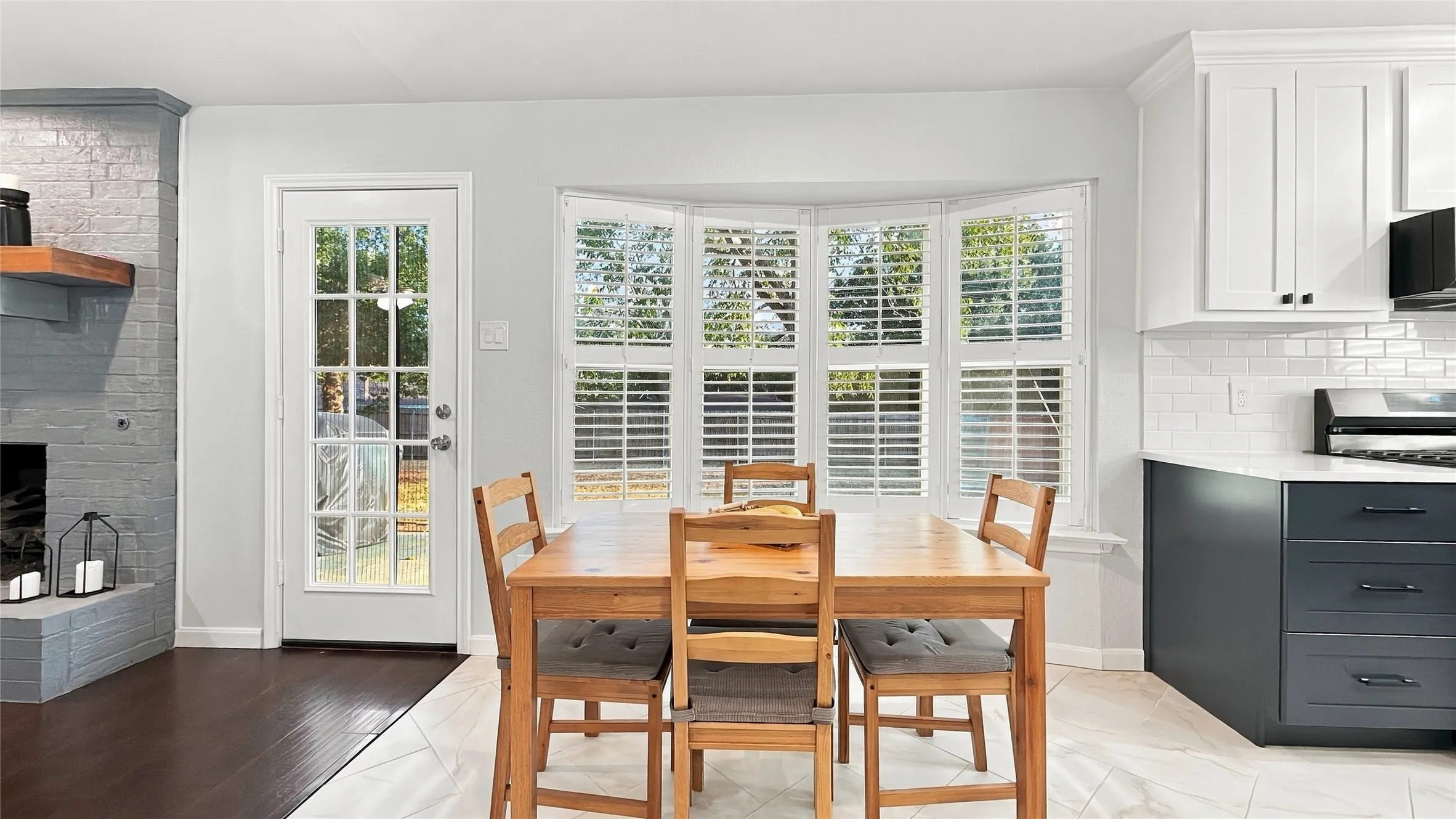 The breakfast area has beautiful bay windows and the French door leads to the backyard.