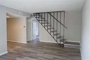 Wood-finish flooring throughout, complemented by light gray wall tones