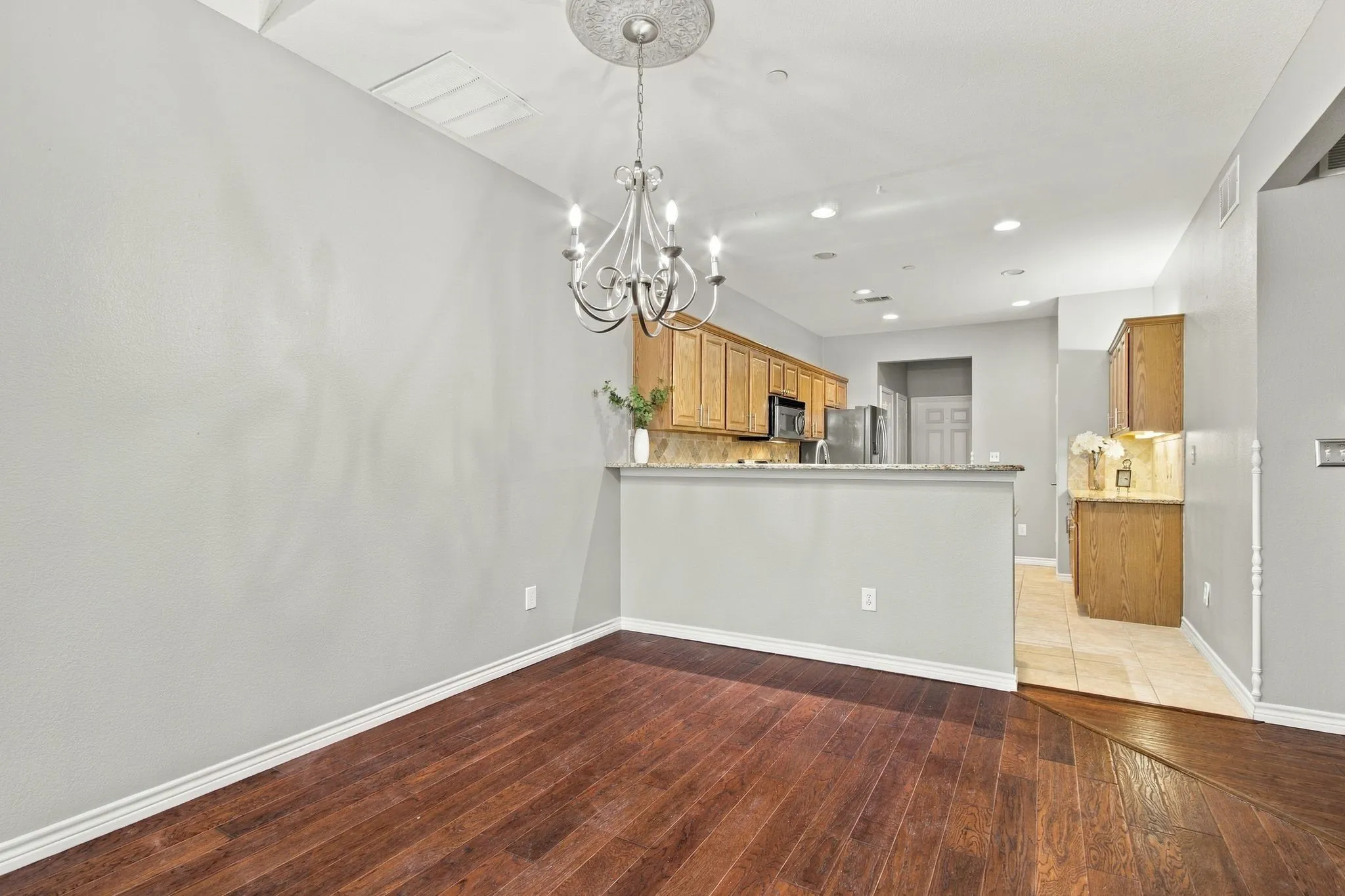 Dining Space Accommodates large dining furniture plus space for bar tools at elevated kitchen breakfast bar.