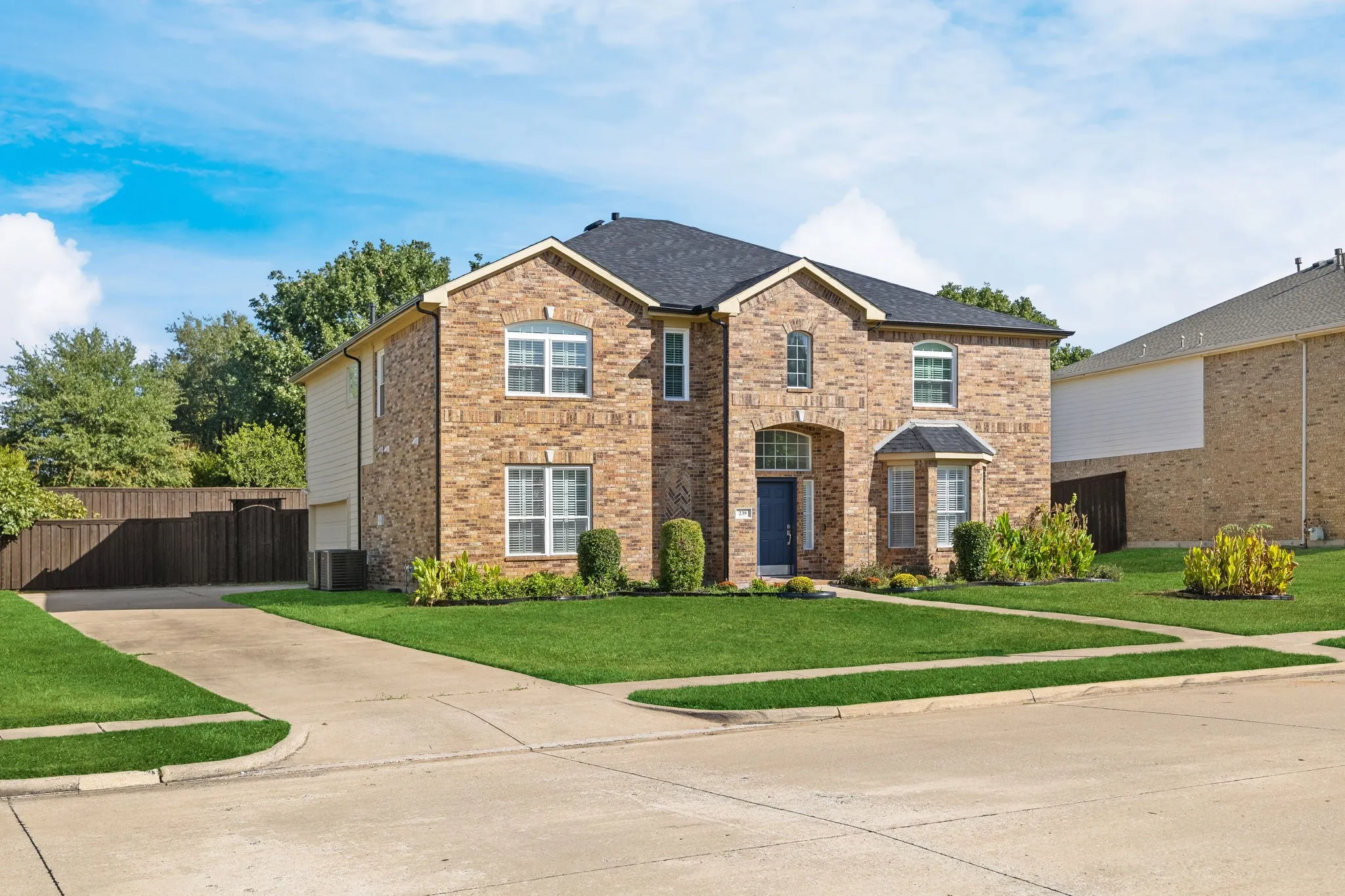 Brick exterior with a dark roof and white trim