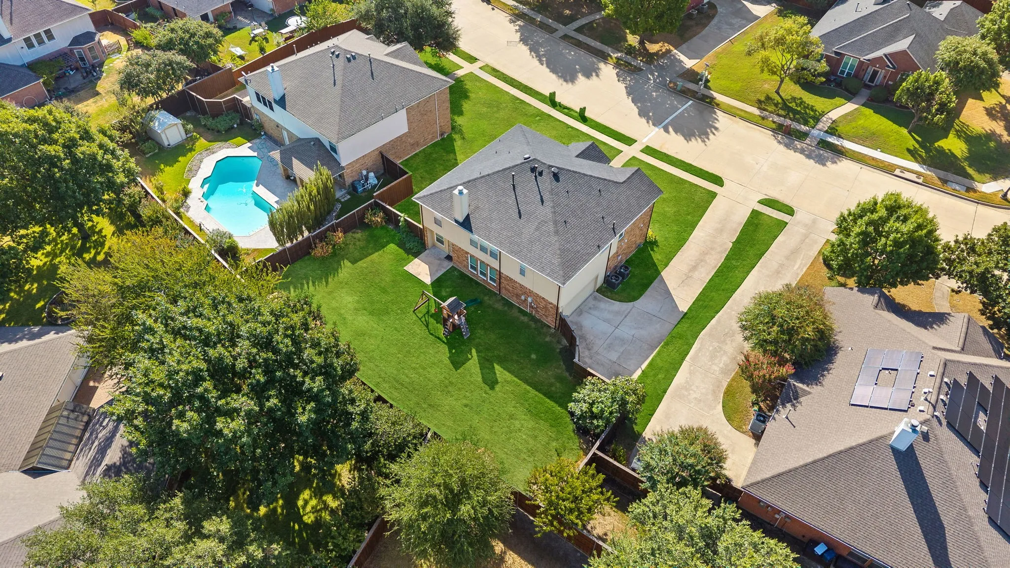 Expansive property with a private backyard, mature trees, and a concrete driveway