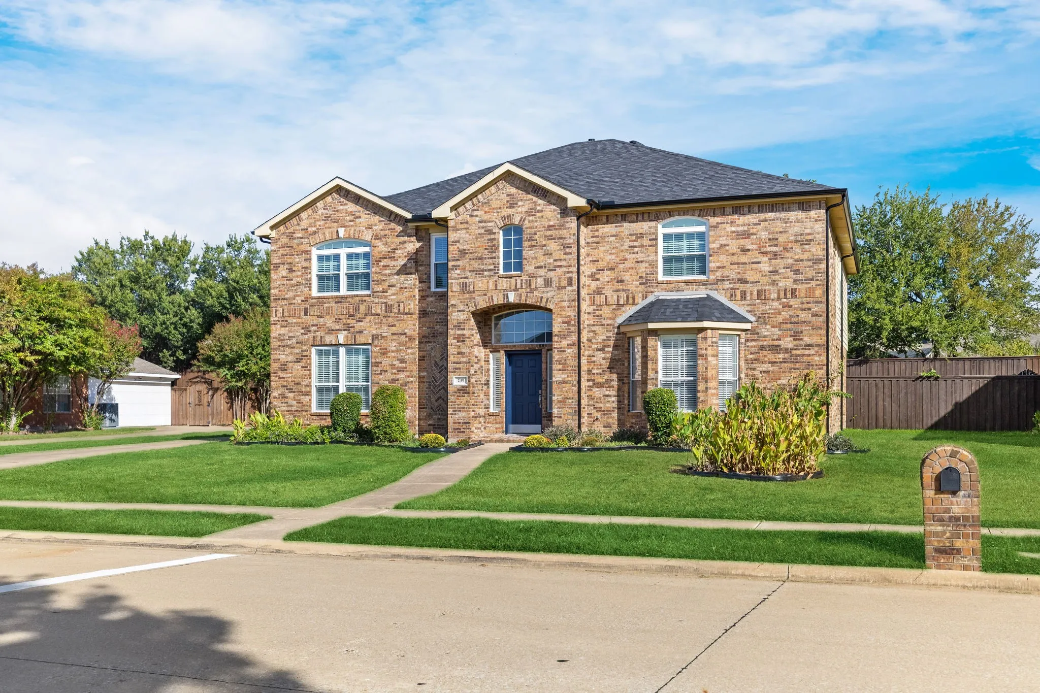 Brick exterior with a dark roof and multiple arched windows