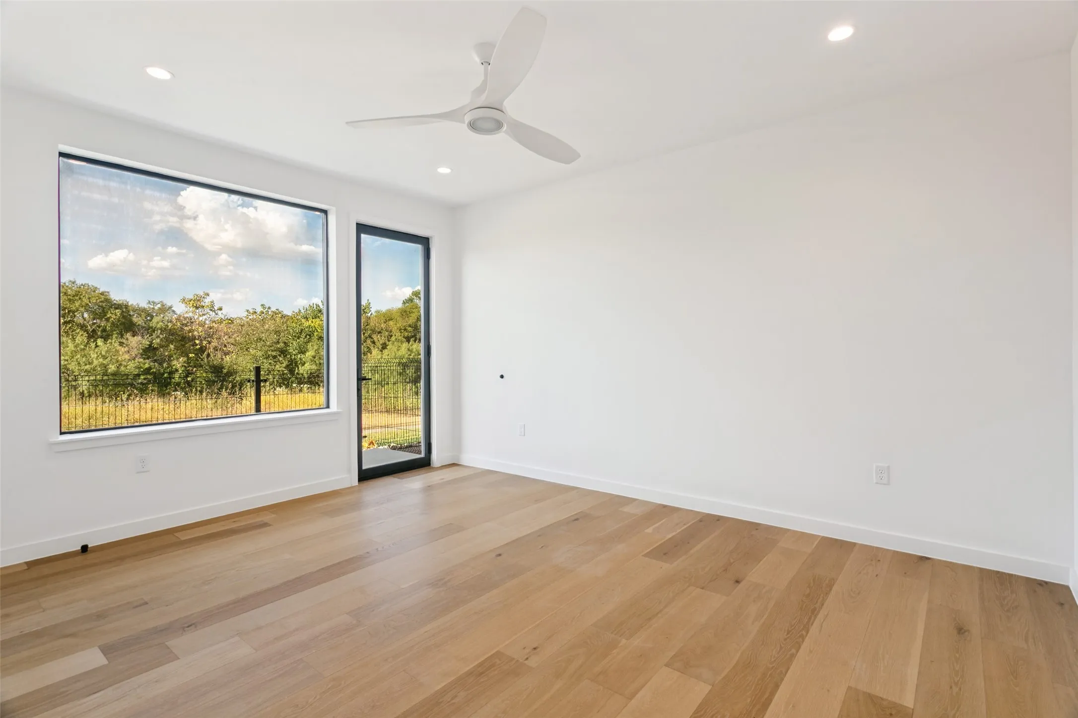 Bedroom with doorway leading to the backyard fenced courtyard.  Walk-in closet.  Full bath and laundry off bedroom.