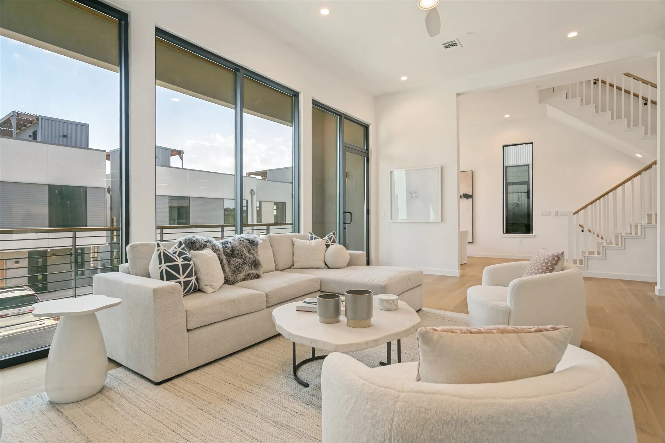 Expansive floor-to-ceiling windows, 12 foot ceilings, balcony across the front.