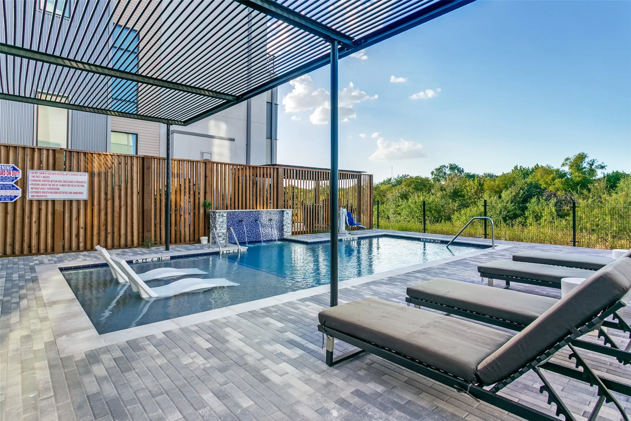 Pool area with fountain, an in-water lounge area, handicap access.  Trail facing.