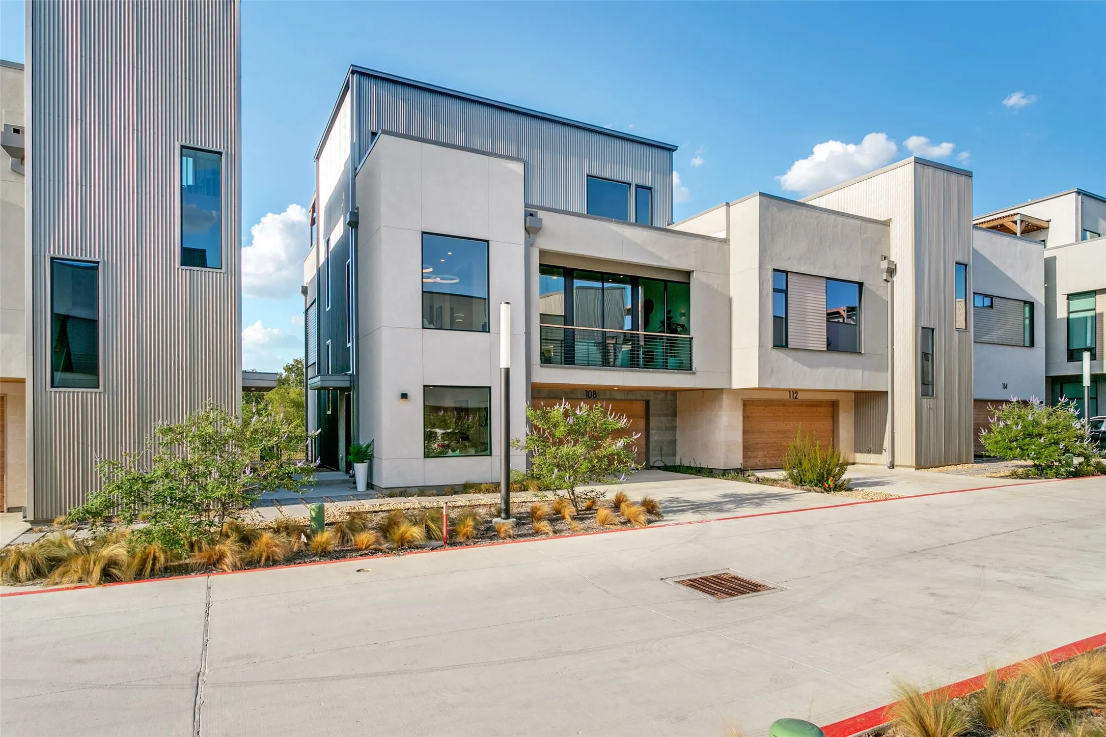 Expansive windows, a recessed balcony, and gorgeous wood double garage doors.  Backing up to the 7 mile greenbelt, running trail.