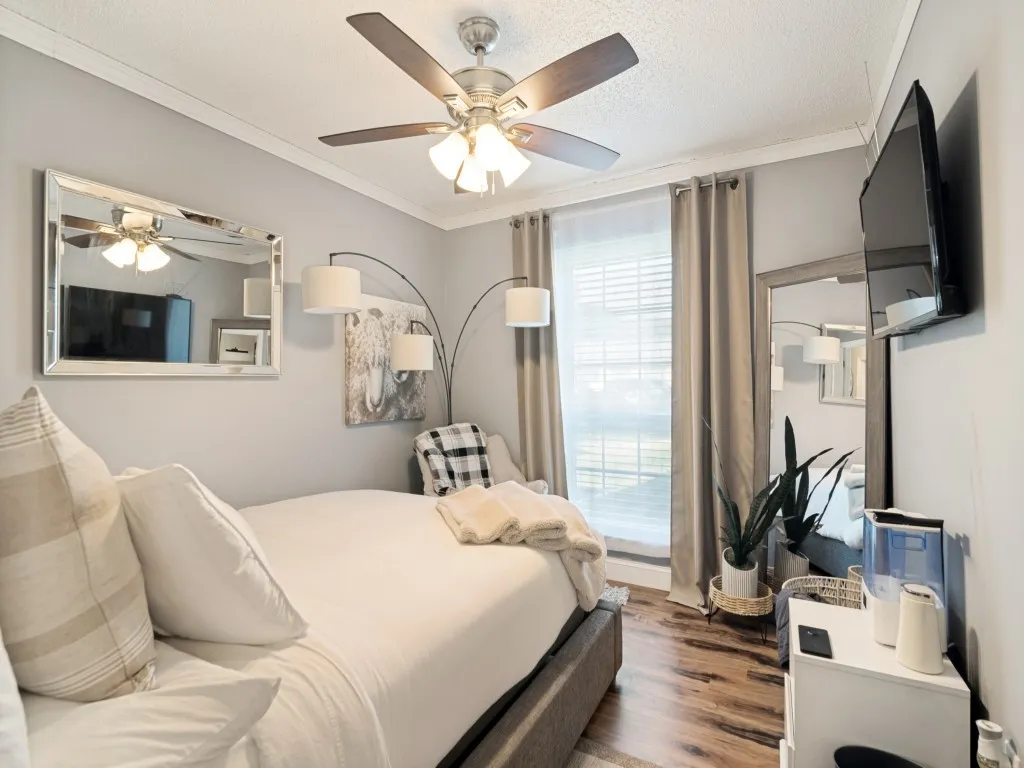 Recessed window with blinds and full-length drapes