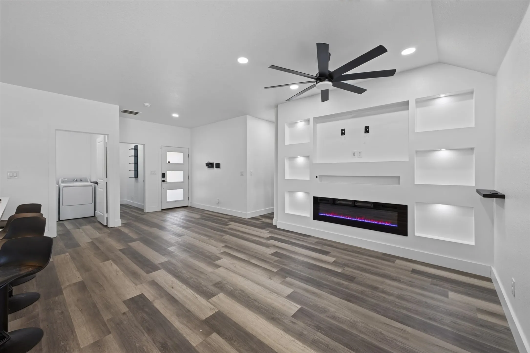 Beautiful flooring, ceiling fan, fireplace this is a cozy space.