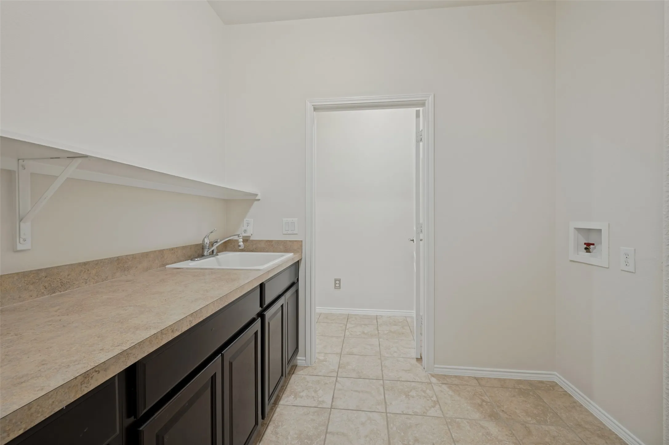 Large Laundry with folding counter, sink, and storage closet (not pictured)