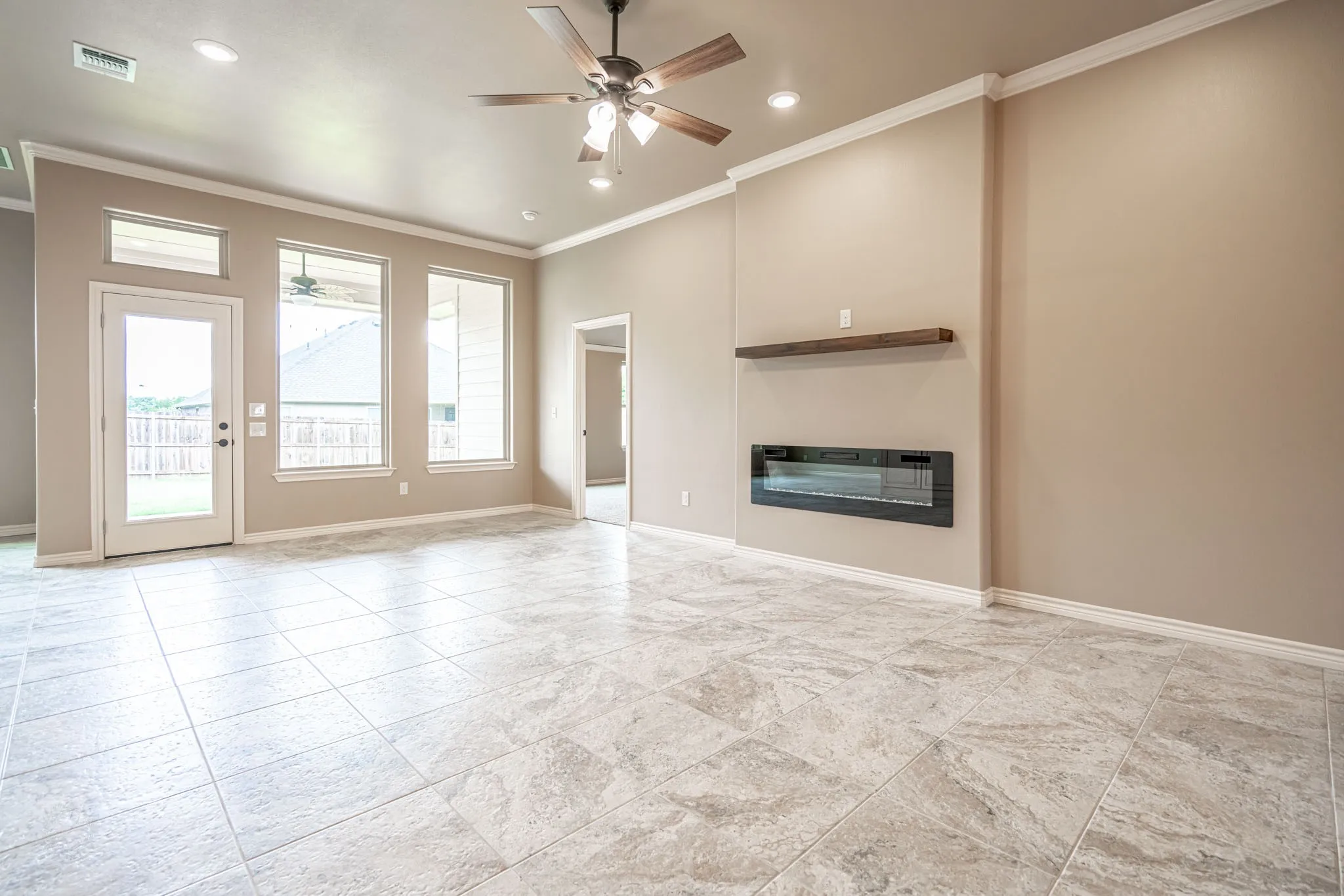 Great room with wall of windows and electric fireplace