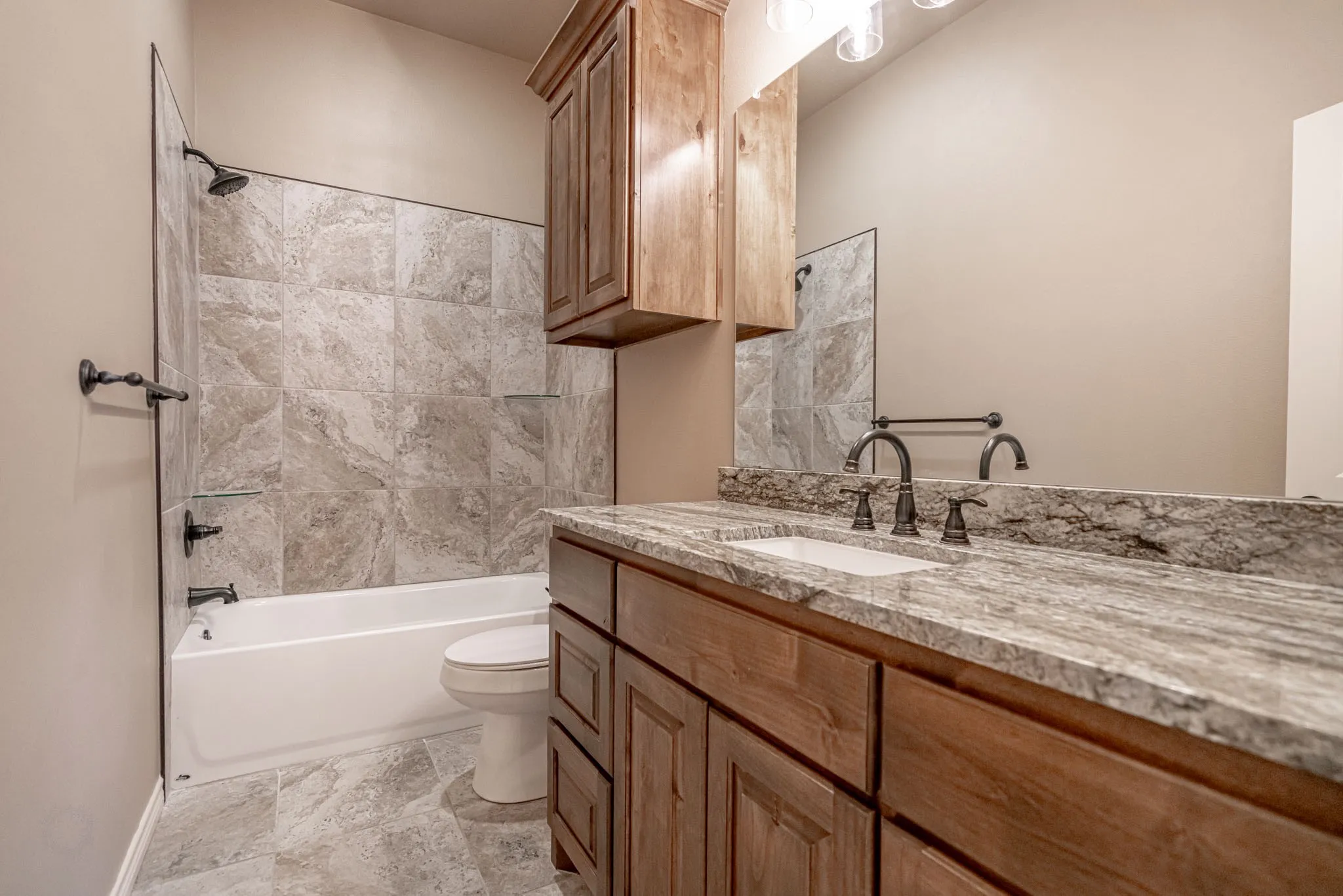 Secondary bath with real tub and tile surround with good sized granite vanity top