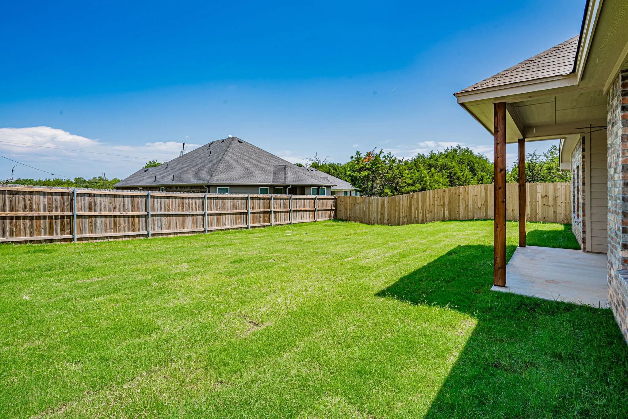 Fully sodded back yard with privacy fence