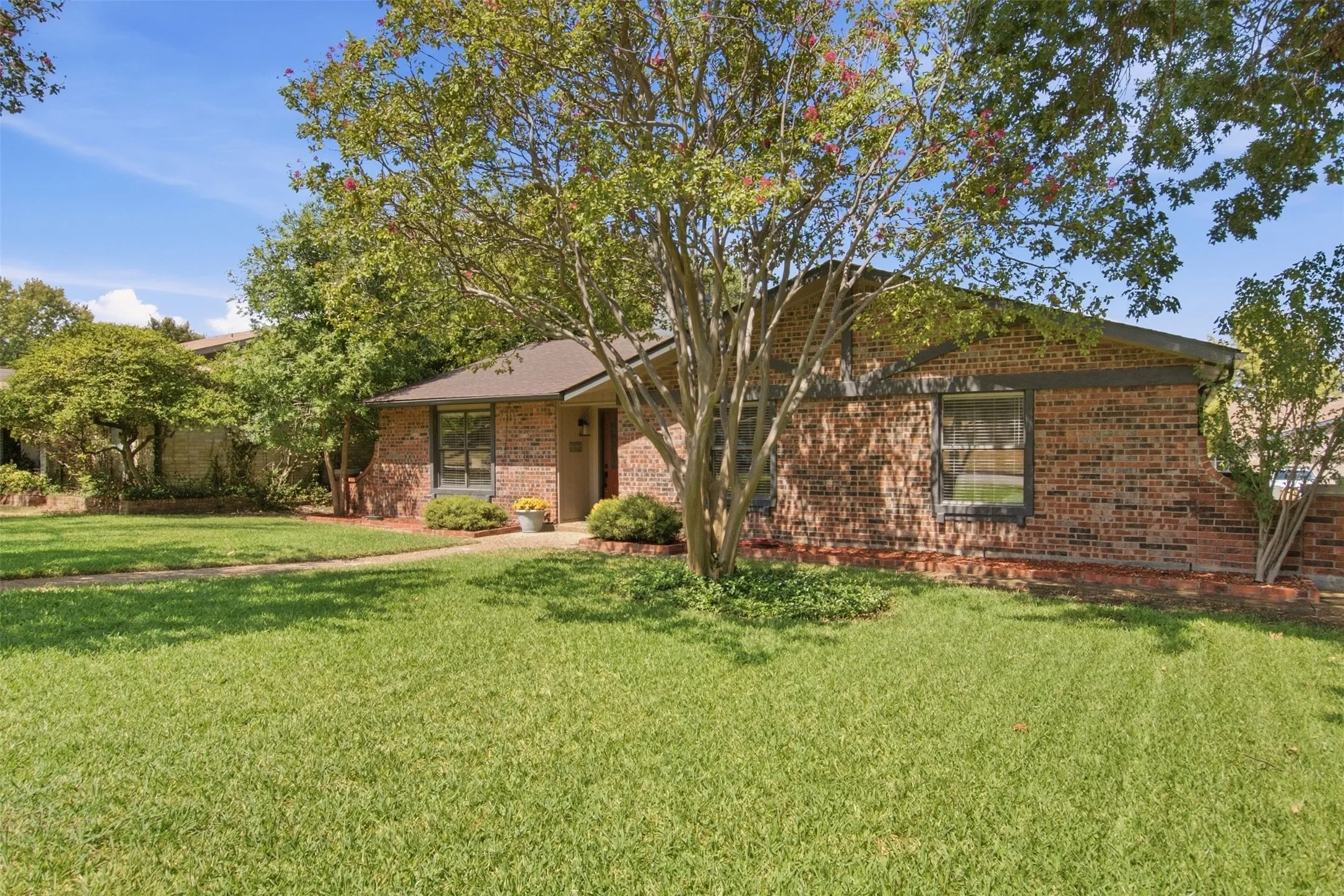 Brick exterior with dark trim and a gabled roof